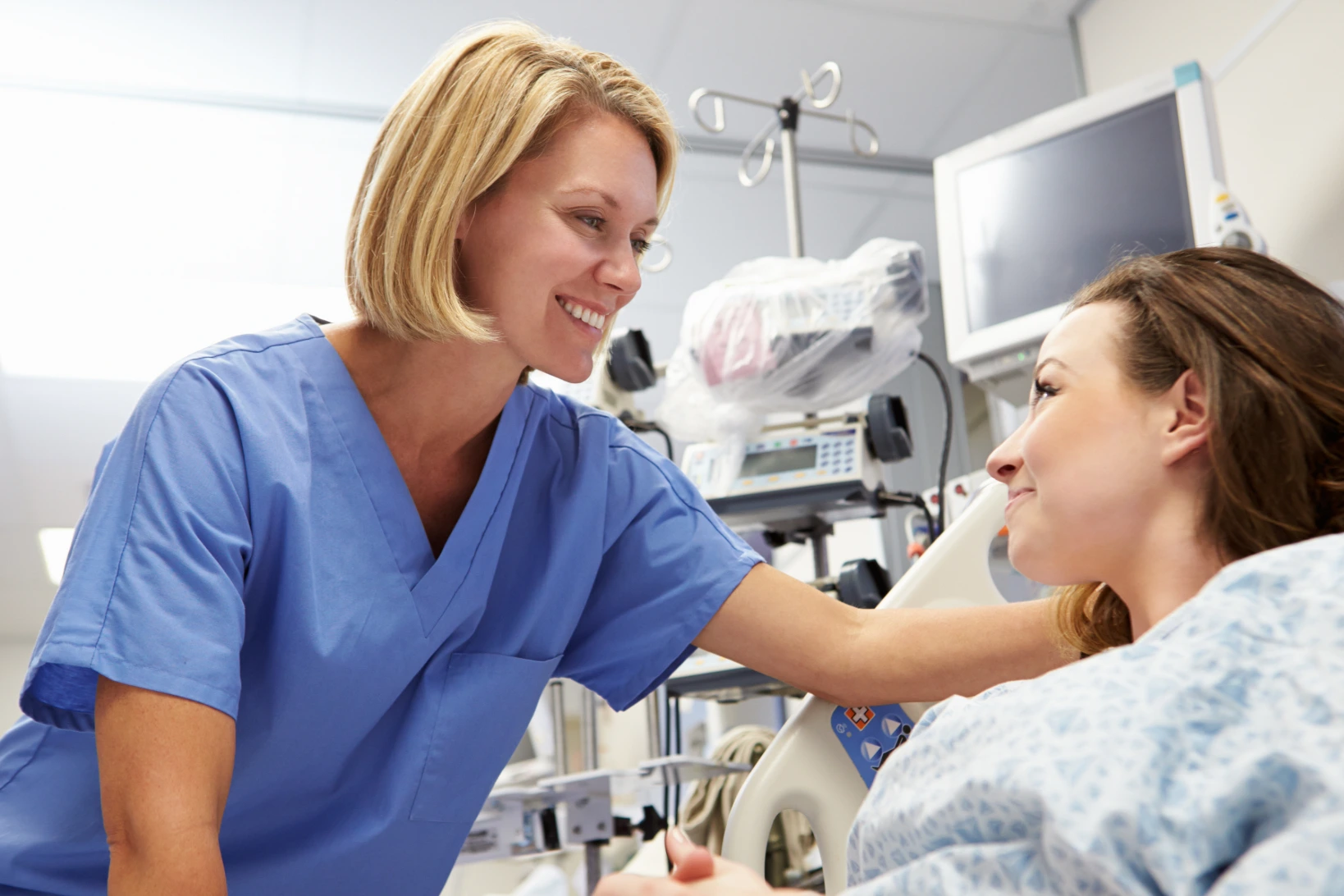 Blonde woman in blue scrubs building patient trust in nursing