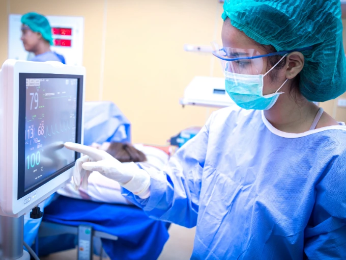 Nurse using technology to monitor patients in STEM career