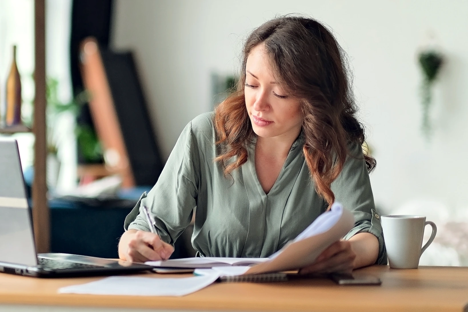 Woman on laptop checking to see if she is on a nursing school waitlist