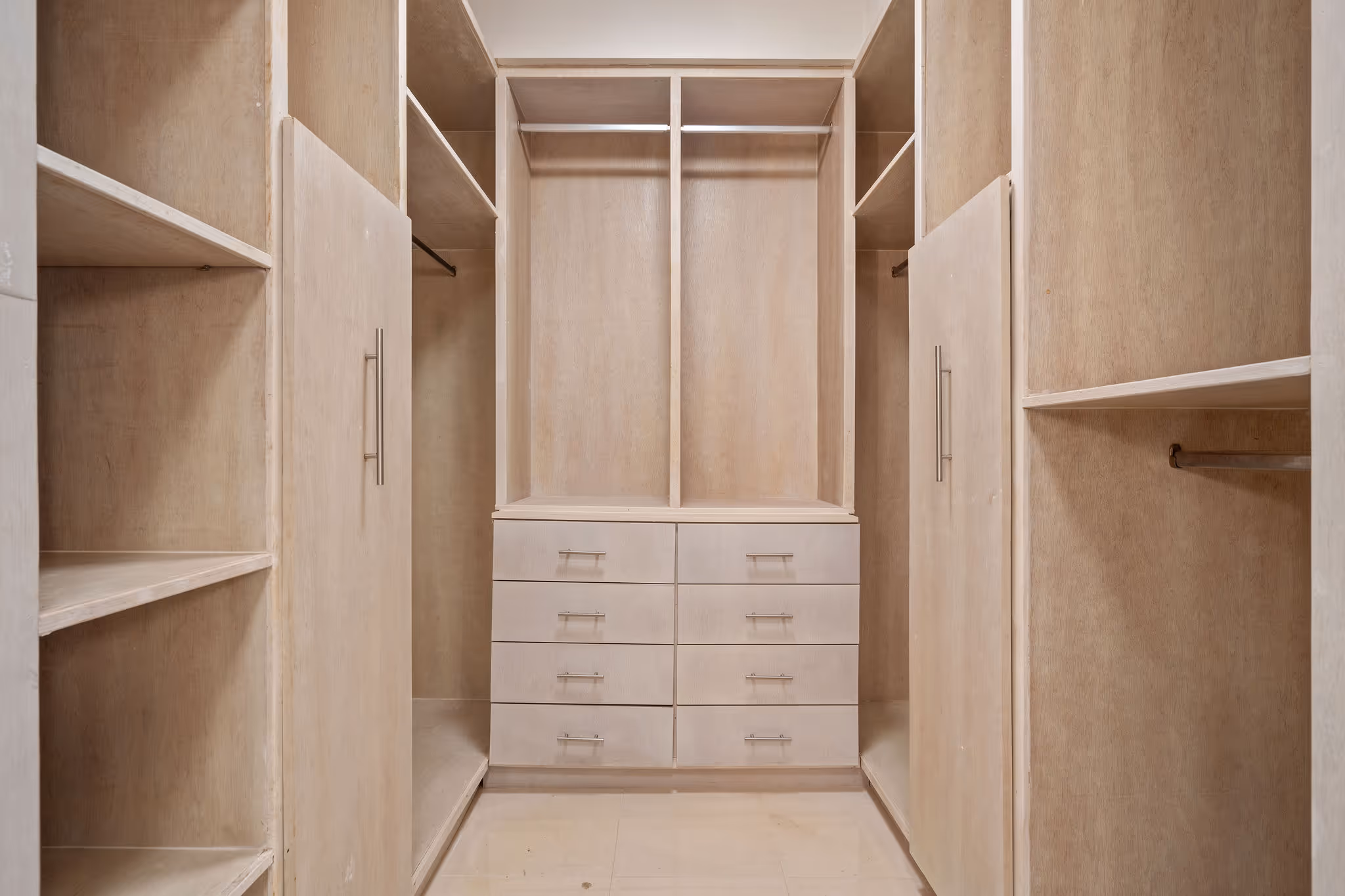 20. Country Club Villas F302 Image 13: Spacious walk-in closet with custom-built shelving, ample storage, and a well-organized layout for a sophisticated lifestyle.