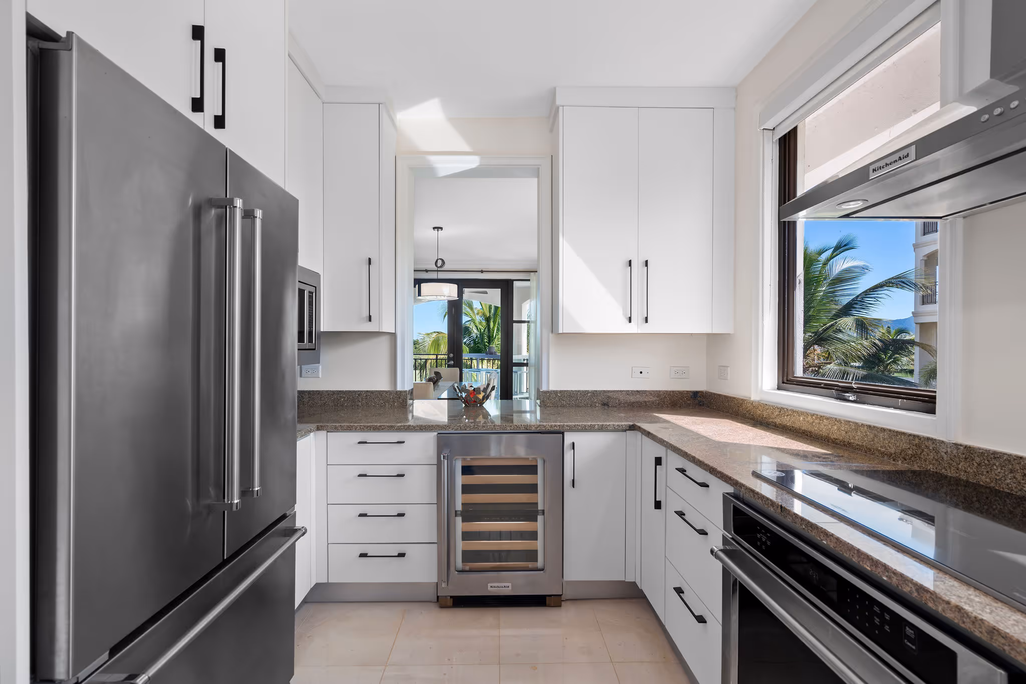 12. Country Club Villas F302 Image 10: Premium wine storage and sleek modern kitchen with high-end finishes and designer appliances.