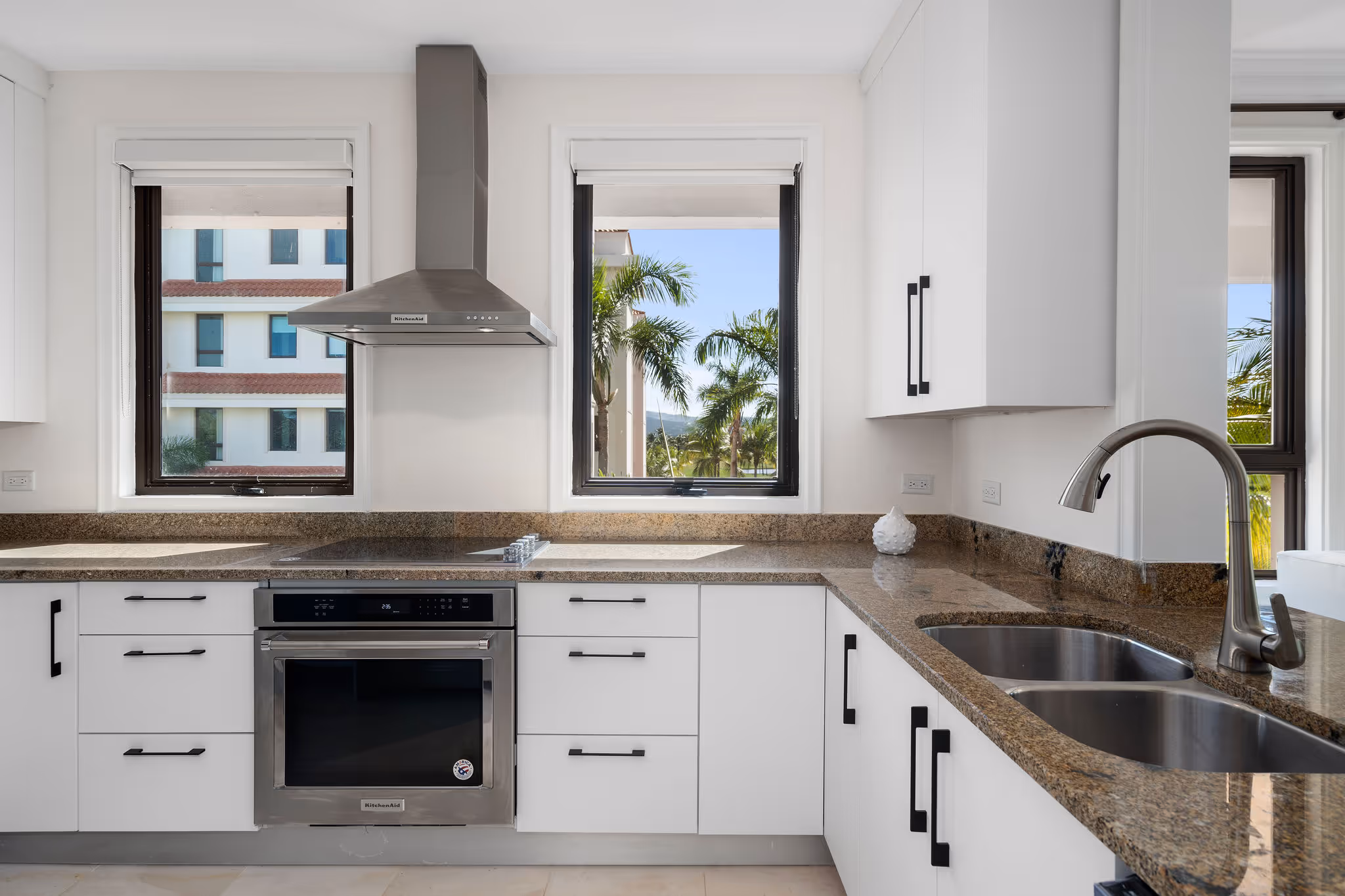 11. Country Club Villas F302 Image 7: Bright and airy kitchen with resort views, ample counter space, and top-of-the-line appliances.