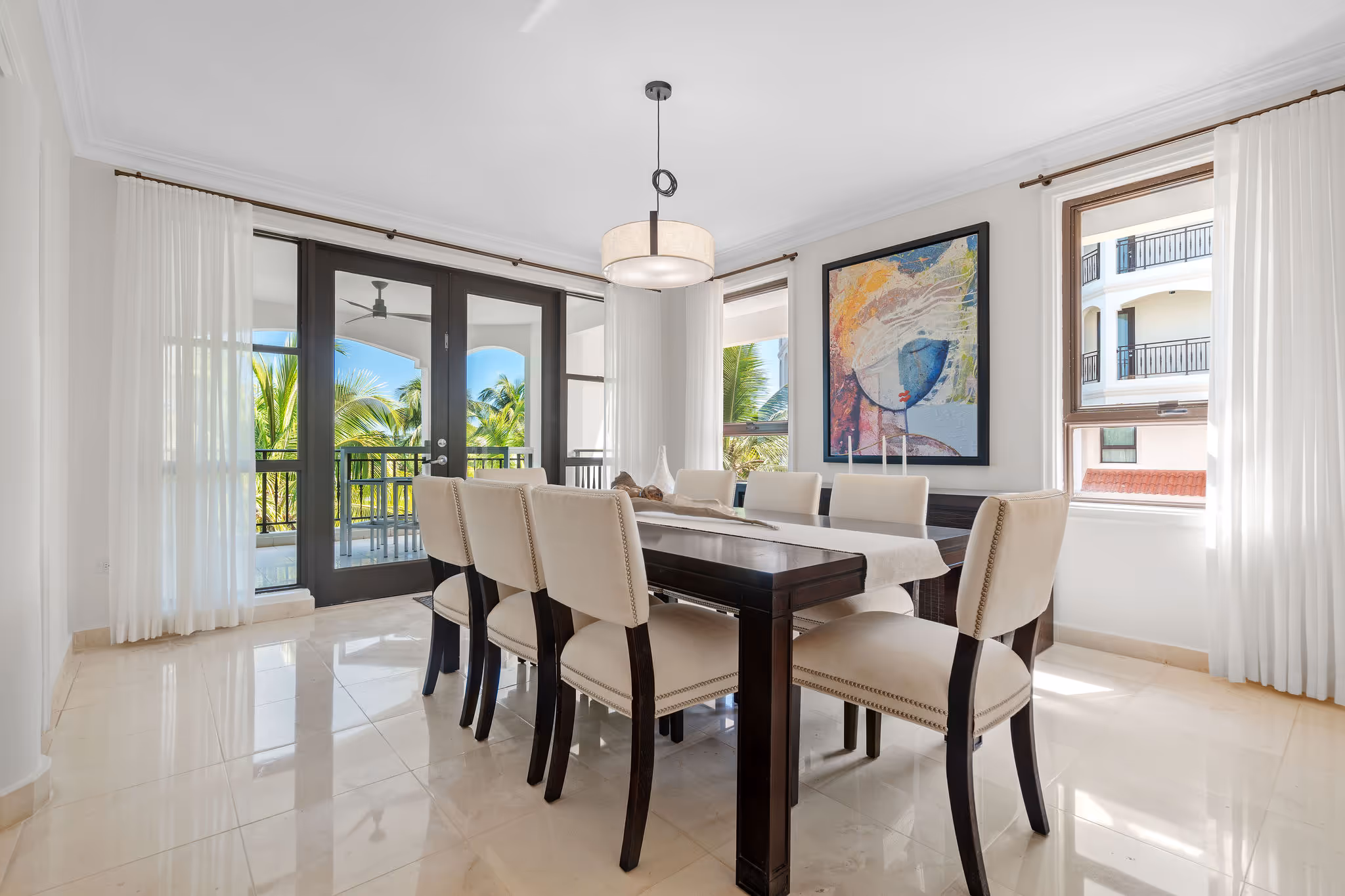 6. Country Club Villas F302 Image 5: Sophisticated dining area with panoramic golf course views and elegant modern lighting.