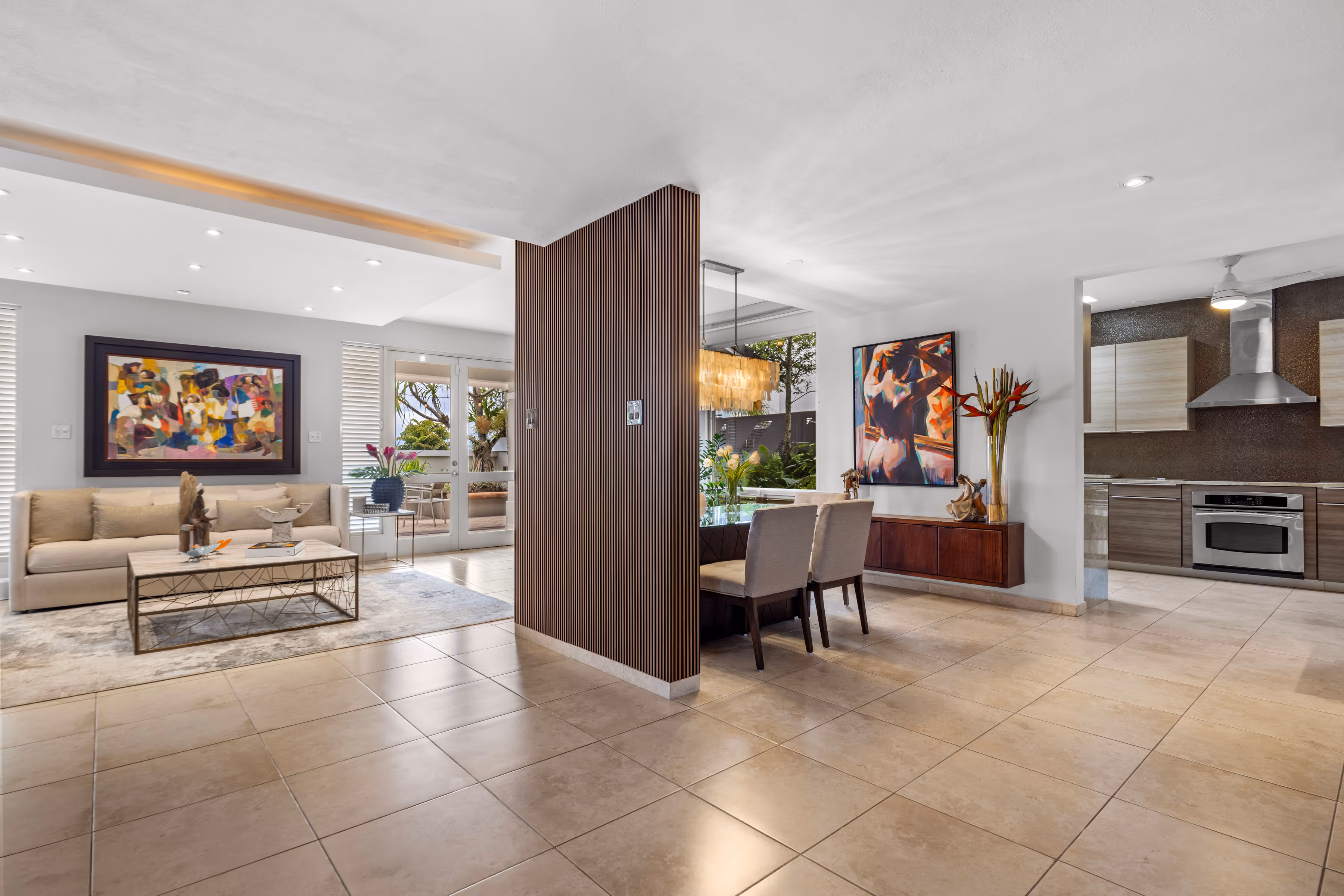 Bright and spacious open-concept living area in a luxury Villas Reales home, featuring modern decor, natural light, and artistic accents.