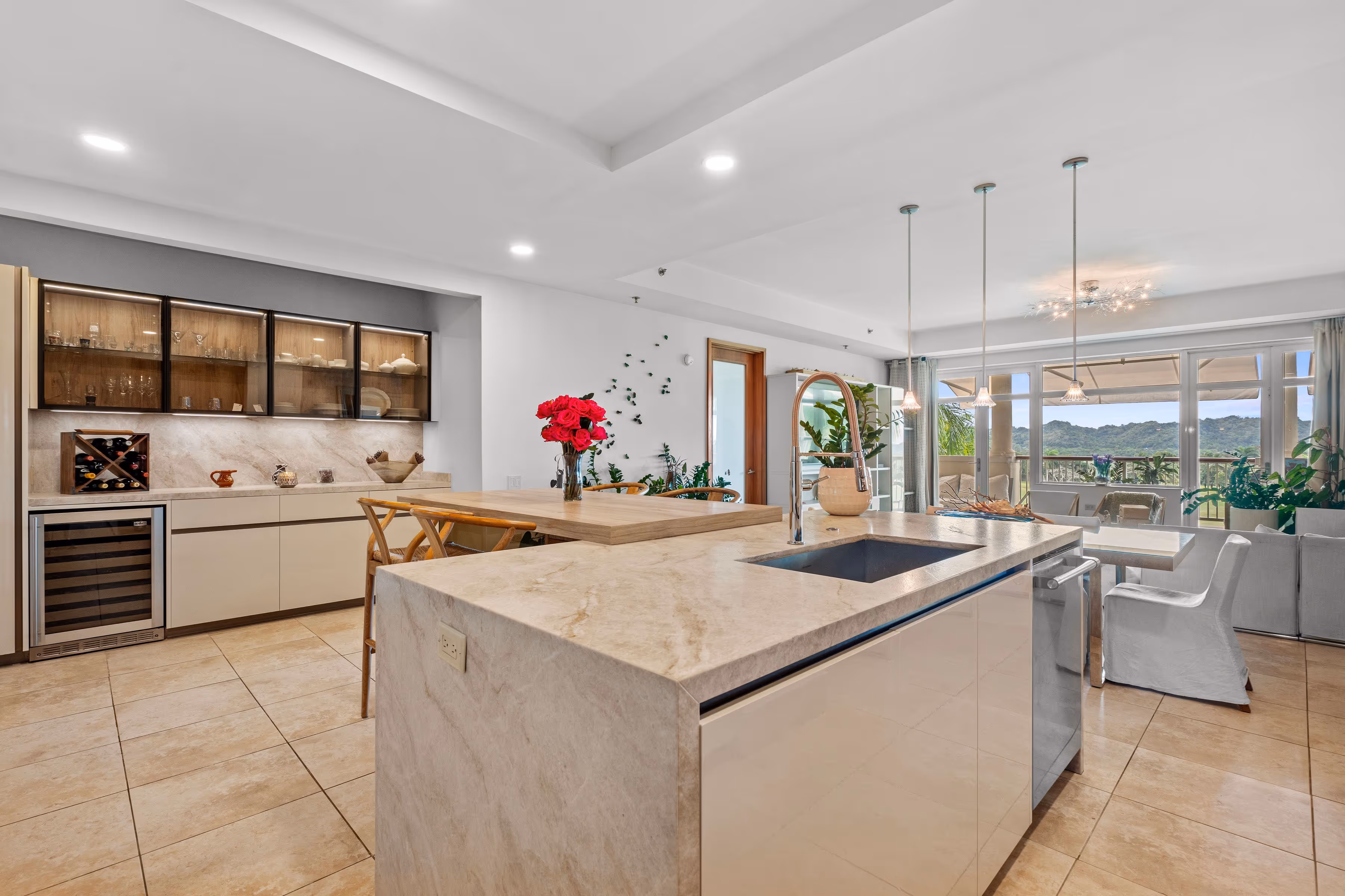 Expansive open kitchen and dining area with marble countertops and natural lighting at Plantation Village, Dorado Beach Resort