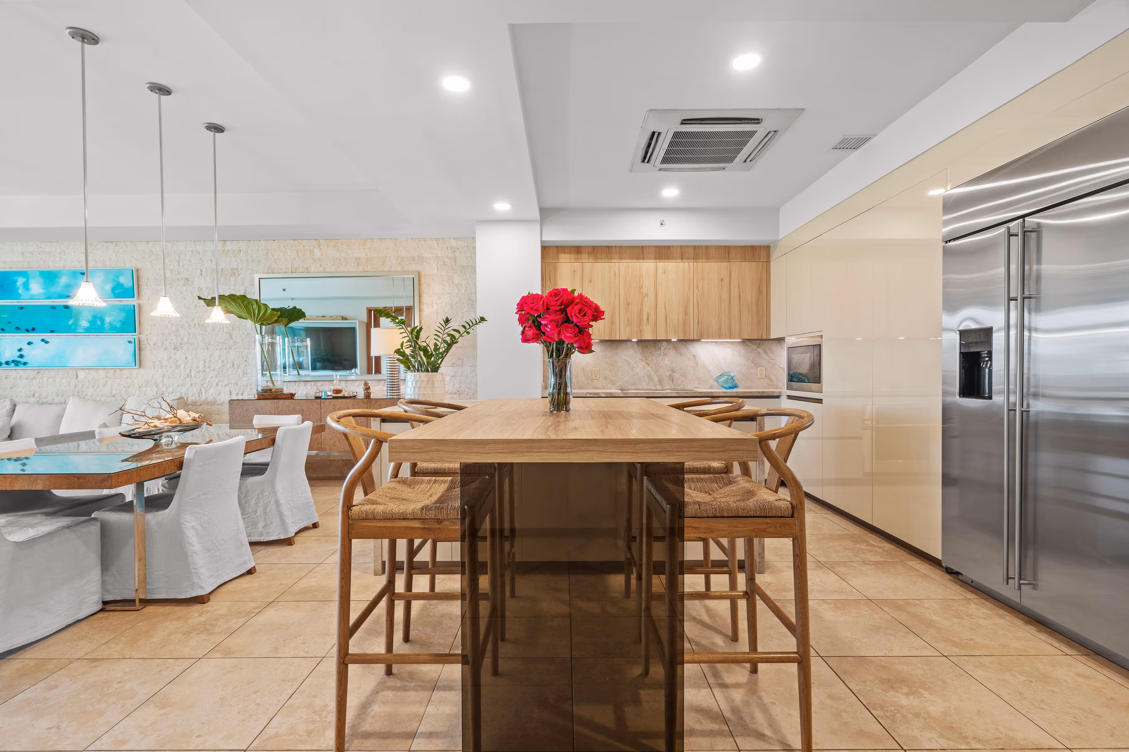 Modern kitchen and dining space with stylish wood accents and marble finishes at Plantation Village, Dorado Beach Resort