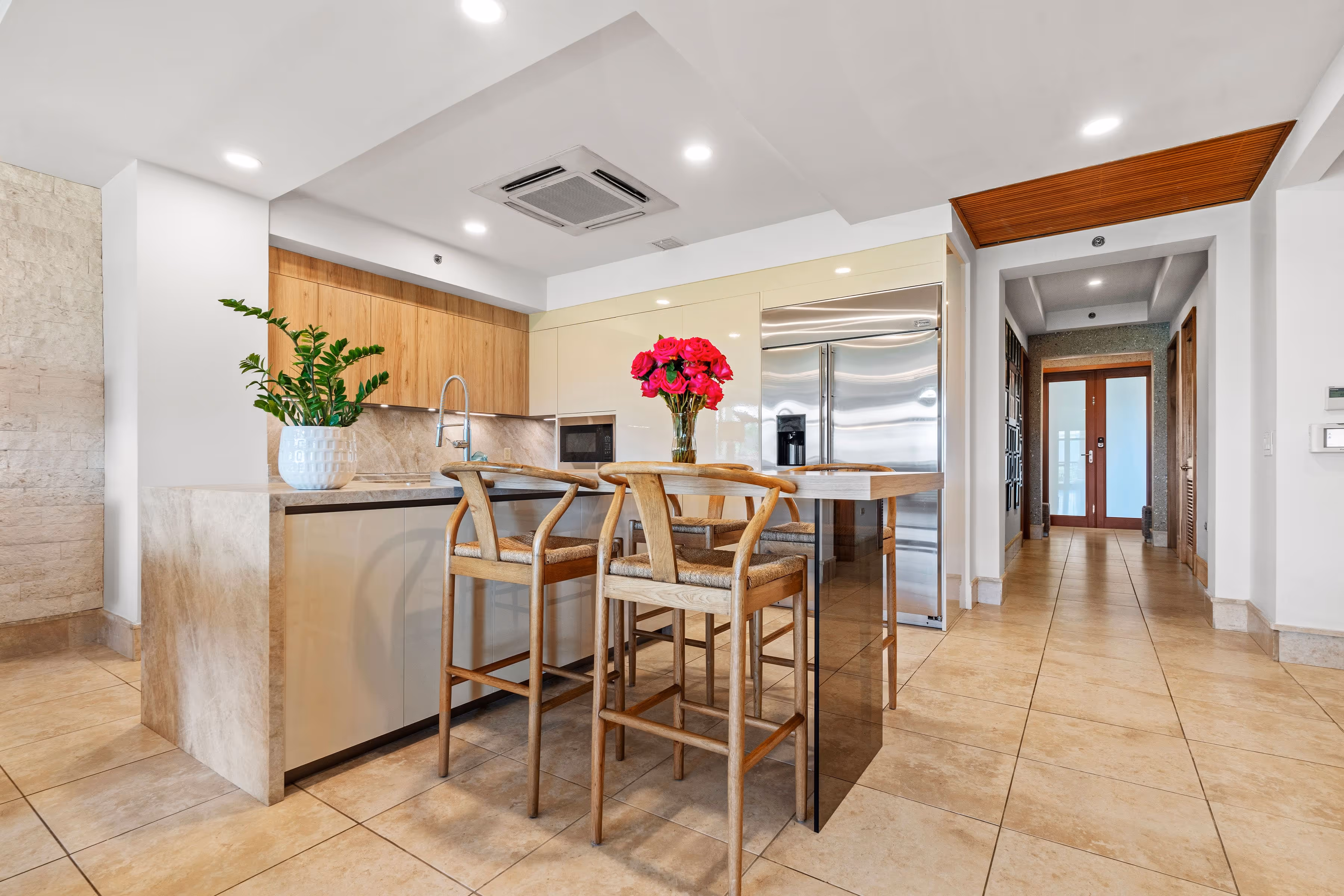 Sleek kitchen island with polished marble surfaces and high-end stainless-steel appliances at Plantation Village, Dorado Beach Resort
