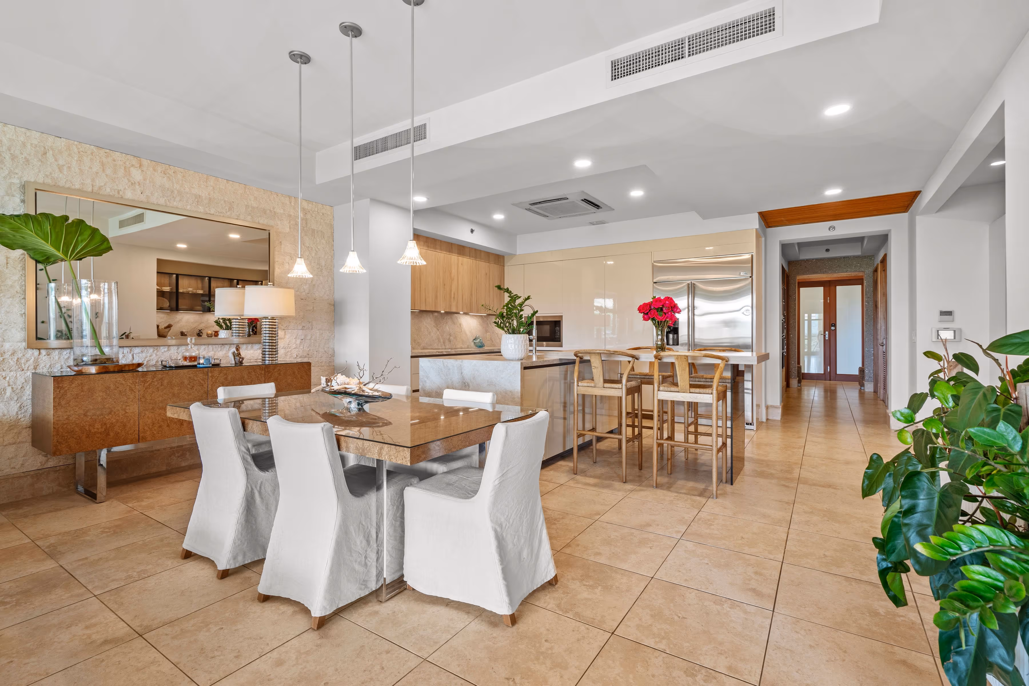 Modern dining and kitchen area with pendant lighting and marble finishes at Plantation Village, Dorado Beach Resort