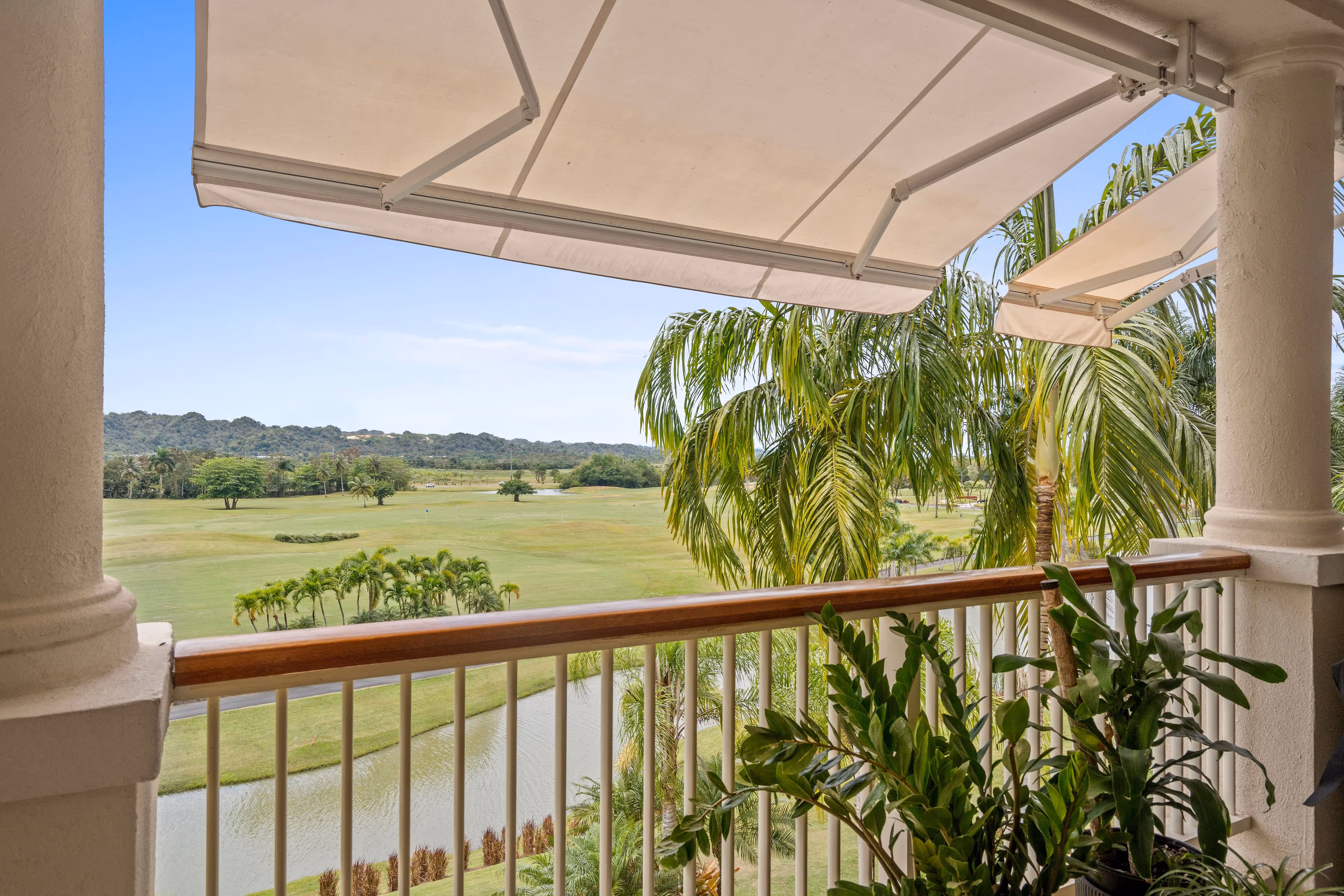Scenic balcony view of lush golf course and tropical landscape at Plantation Village, Dorado Beach Resort