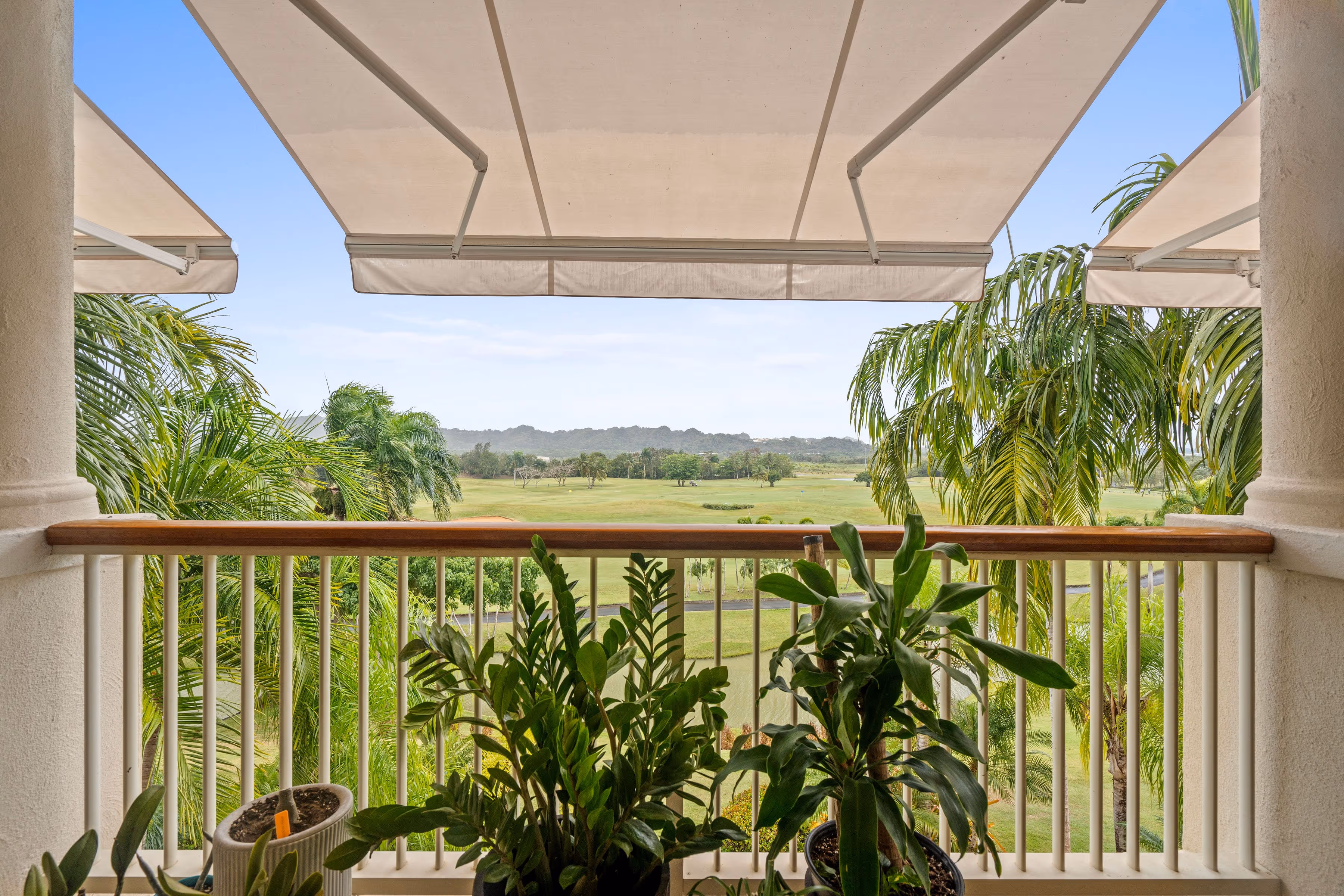 Panoramic view of golf course and greenery from private balcony at Plantation Village, Dorado Beach Resort