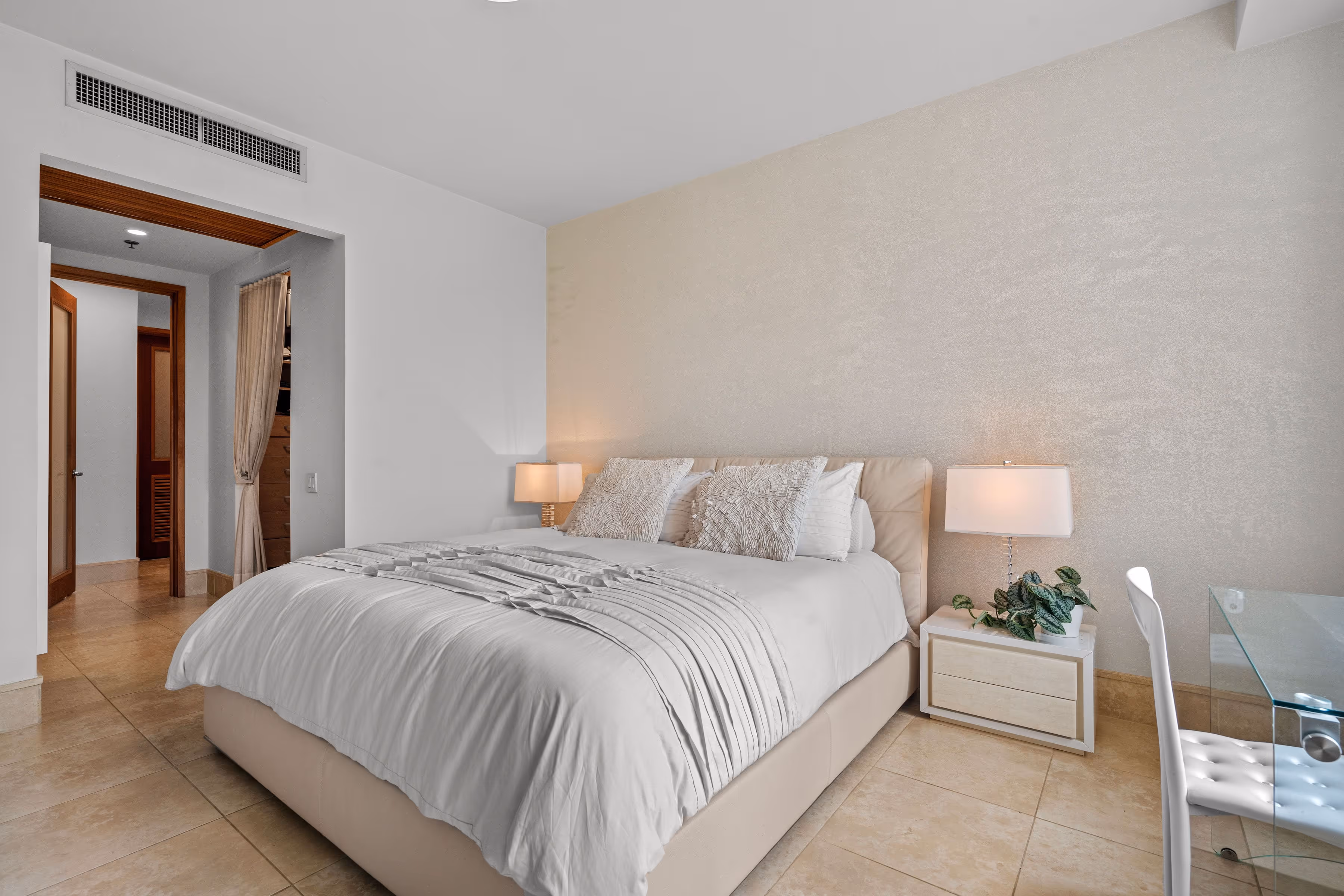 Elegant bedroom with modern decor and luxurious bedding at Plantation Village, Dorado Beach Resort