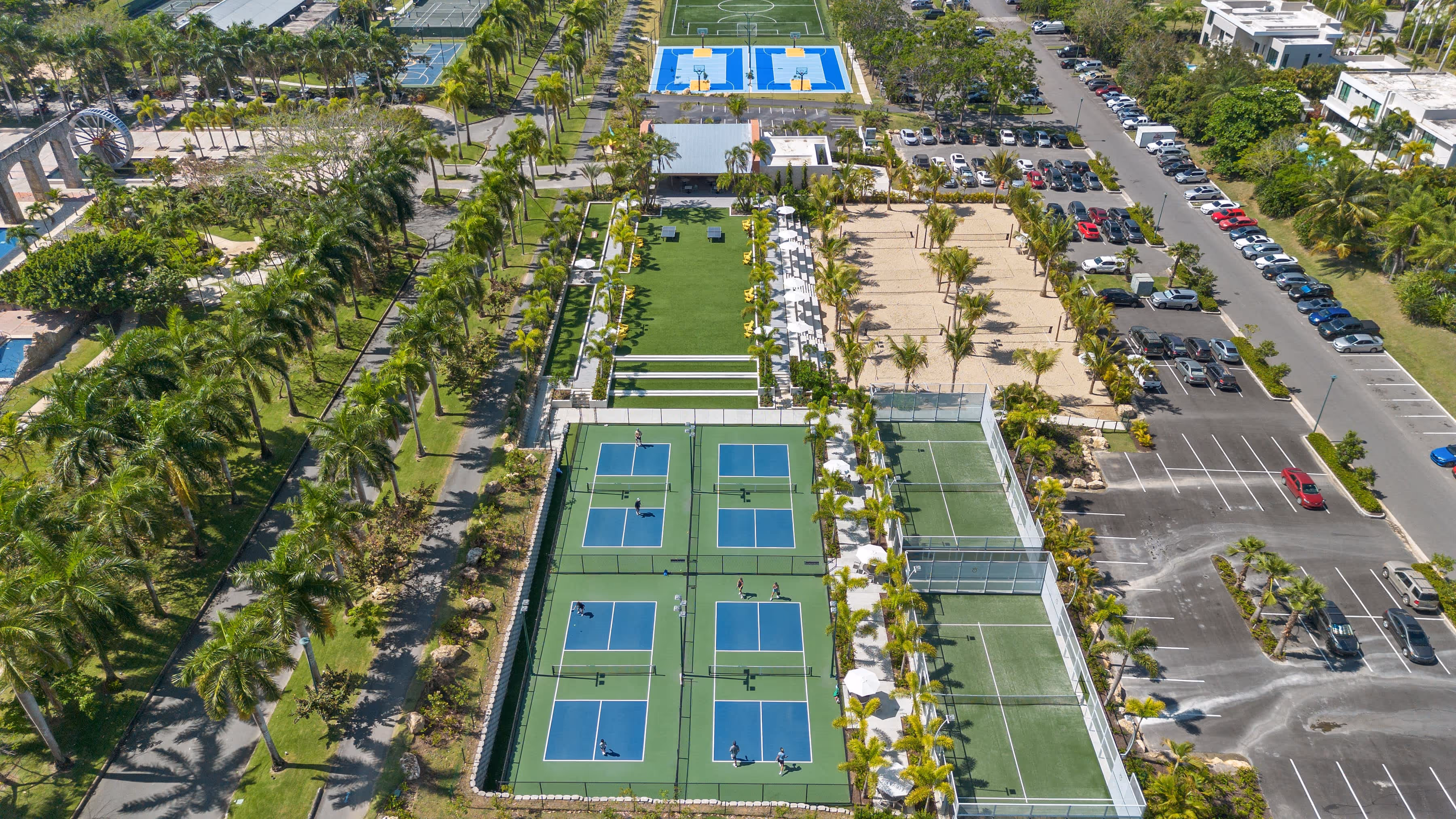 Aerial view of premium sports facilities including tennis and basketball courts at Dorado Beach Resort
