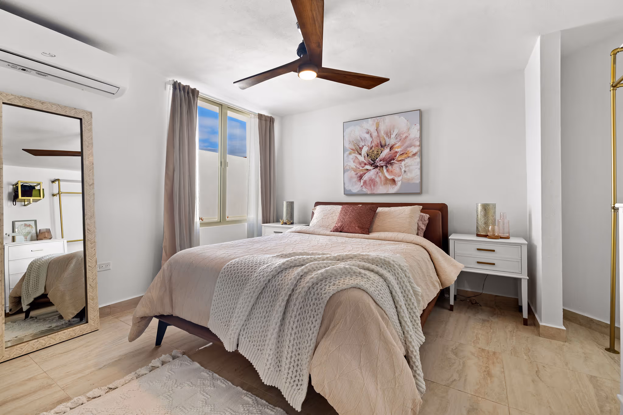 Modern guest bedroom with soft color tones and floral art in luxury residence at Sabanera Dorado