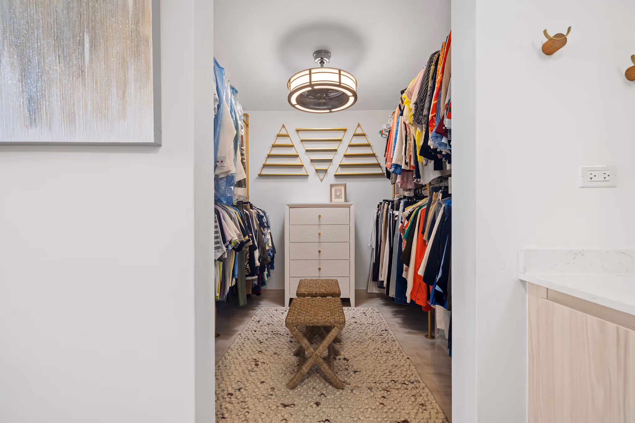 Spacious walk-in closet with custom shelving and lighting in Isla de las Flores sustainable residence