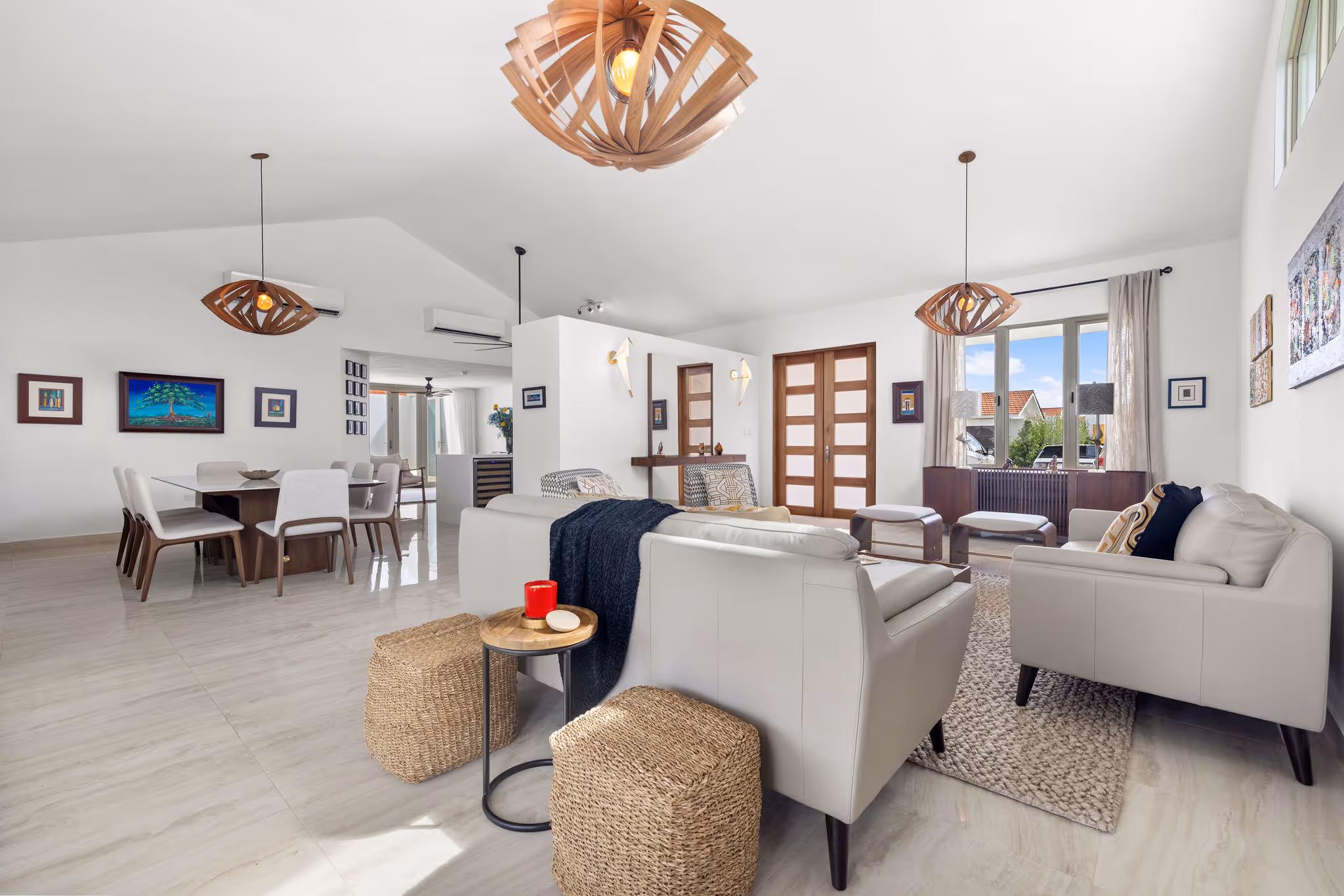 Spacious open-concept living and dining area in high-end Isla de las Flores home with designer lighting