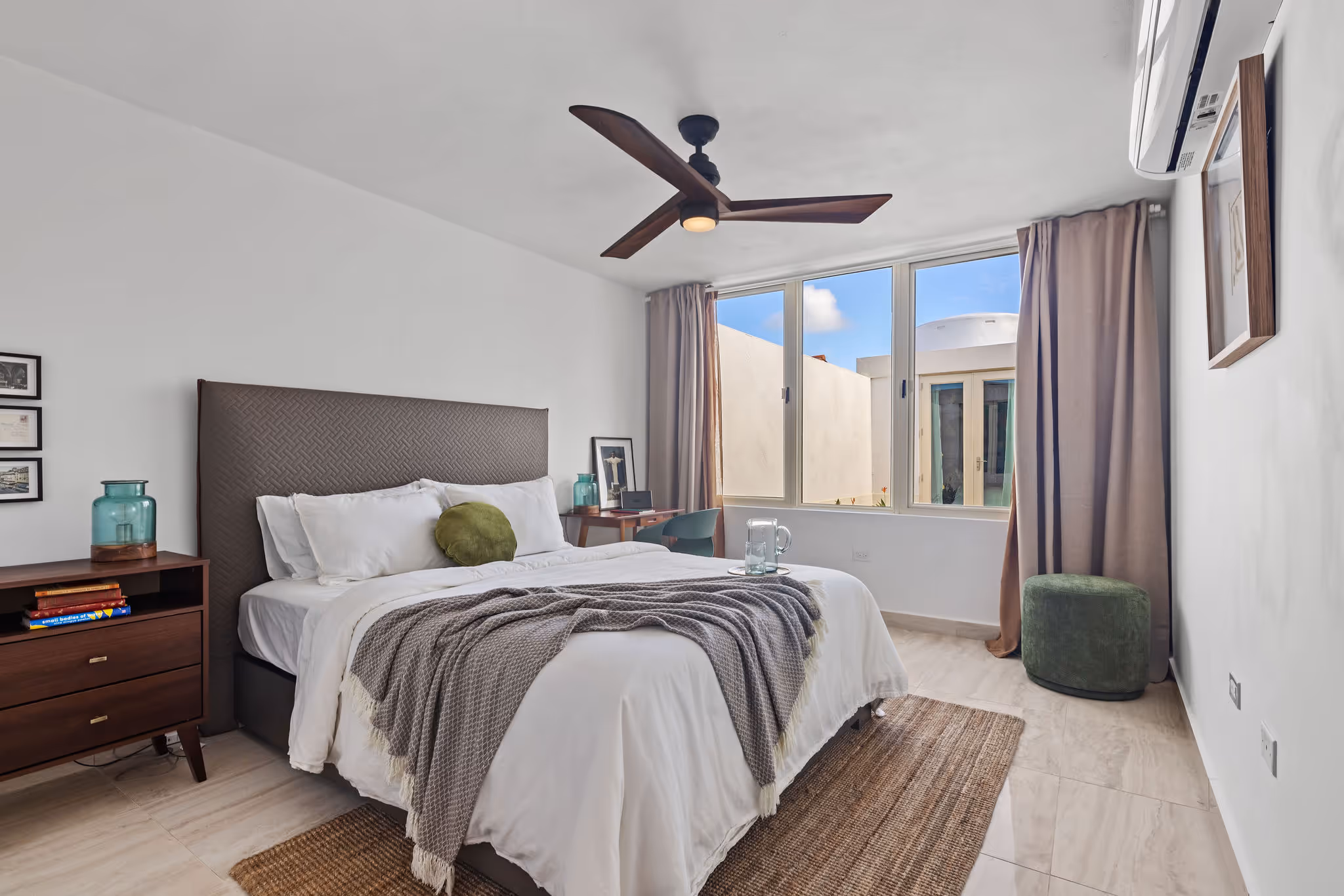 Stylish bedroom with workspace and large windows in eco-conscious Isla de las Flores property
