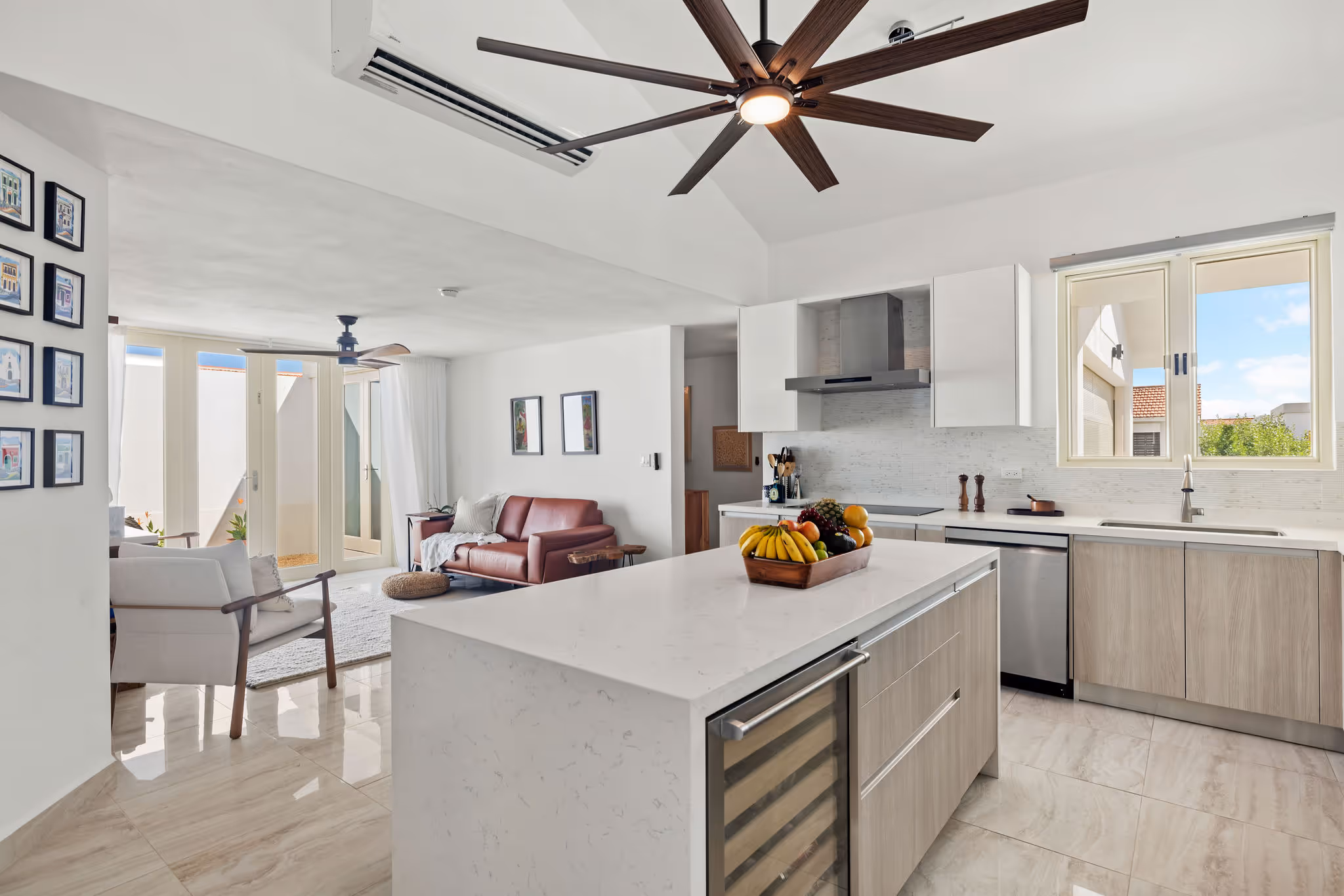 View of kitchen and cozy lounge area with energy-efficient design in luxury Sabanera Dorado residence