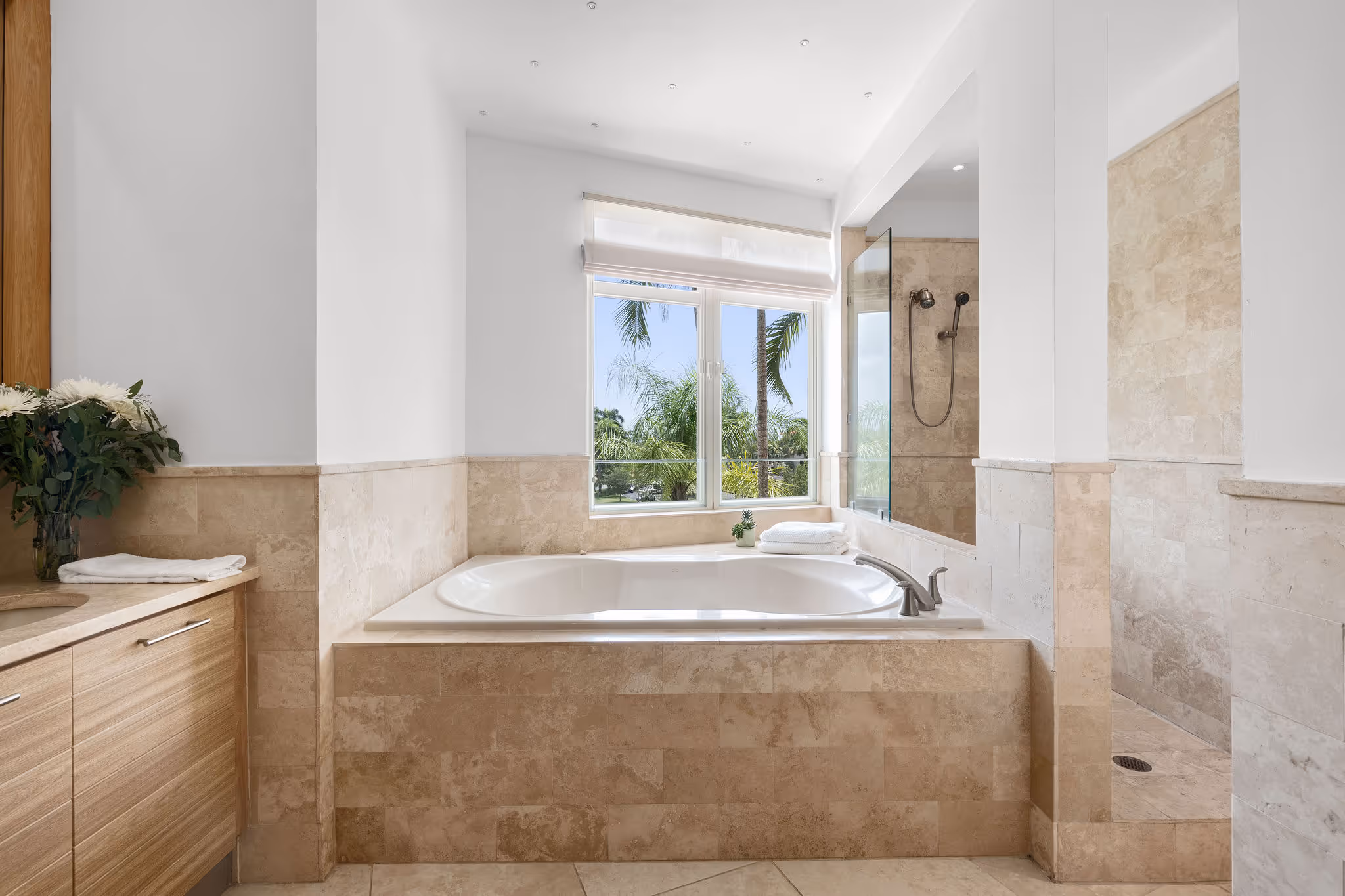 Spa-style bathroom with soaking tub, walk-in shower, and large window at Dorado Beach Plantation Village residence