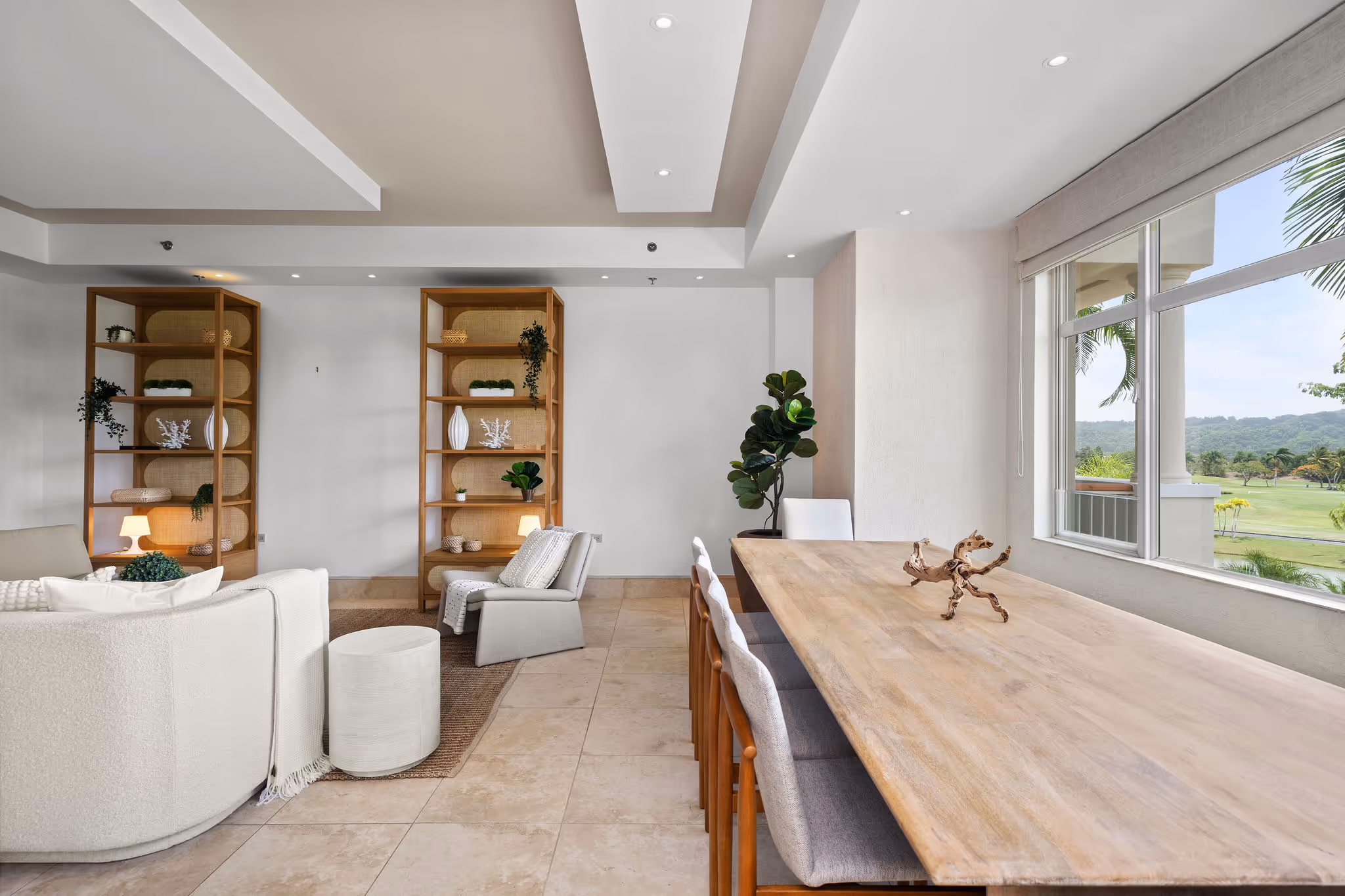 Cozy reading nook and open living area with natural light and lush tropical views at Dorado Beach Resort residence