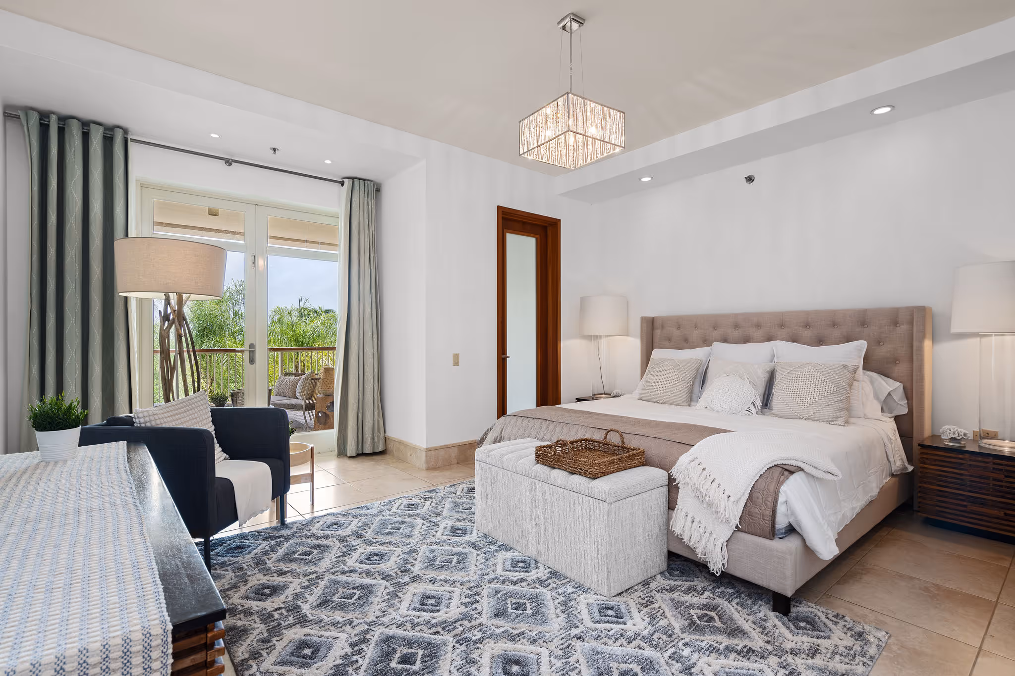 Elegant primary bedroom with balcony access and resort views at Dorado Beach Plantation Village condo