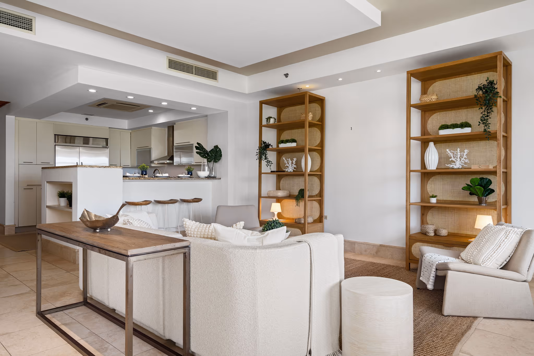 Elegant living space with neutral decor and bar seating adjacent to kitchen in Dorado Beach luxury condominium