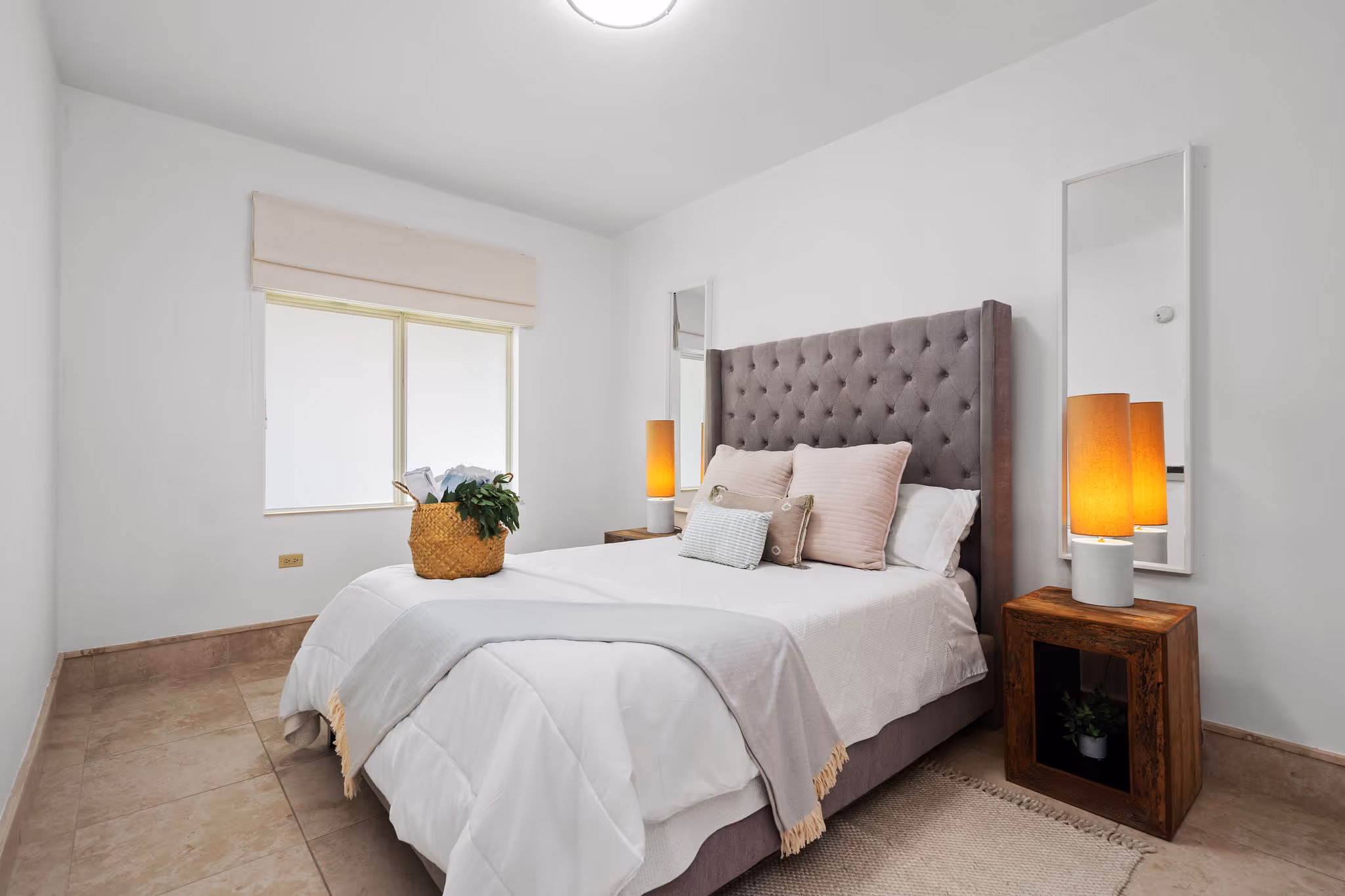 Guest bedroom with tufted headboard and warm accent lighting in Dorado Beach Plantation Village condo