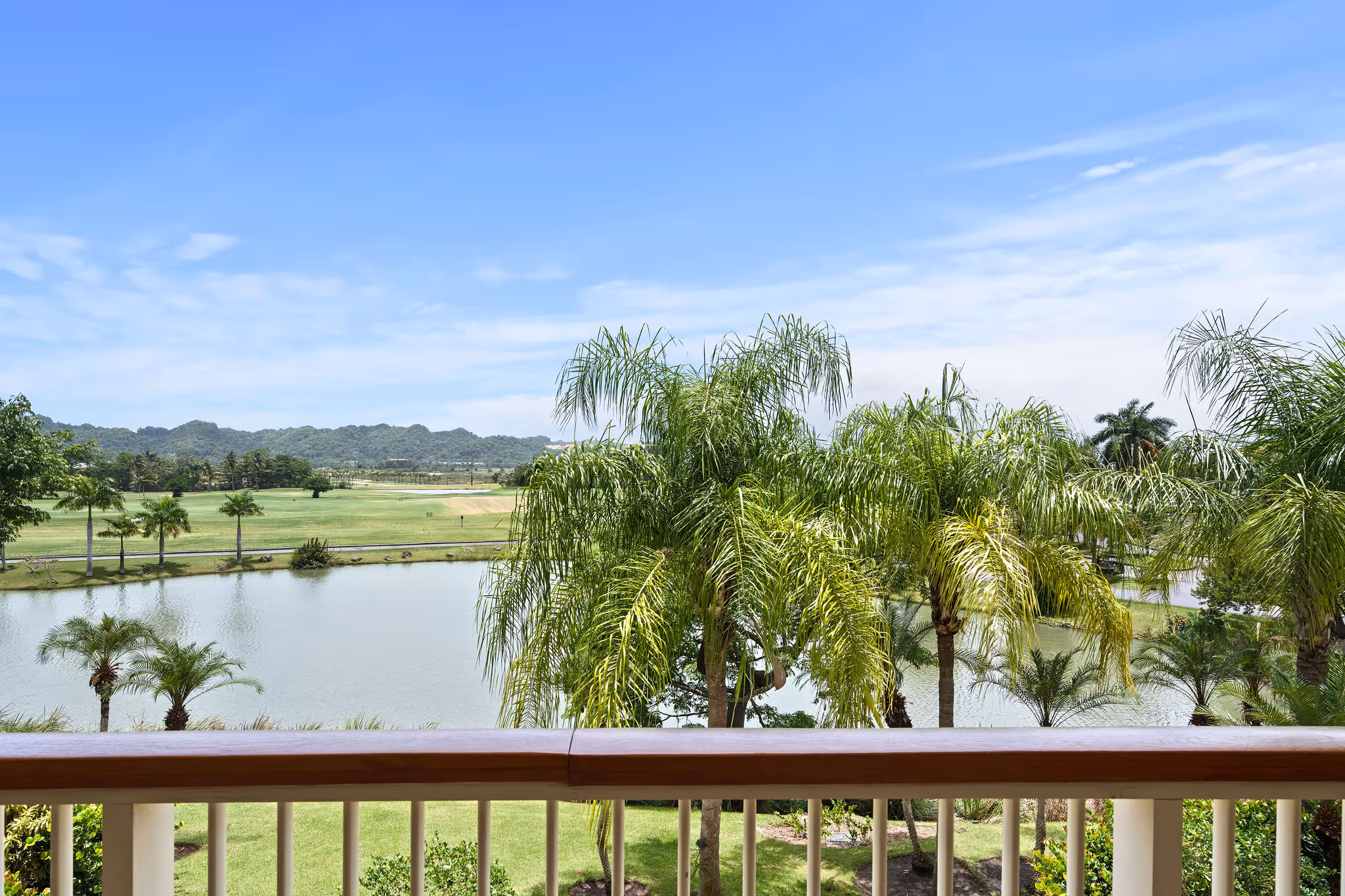 Scenic view of TPC Sugarcane Golf Course and tranquil water feature from balcony at Dorado Beach Resort condo