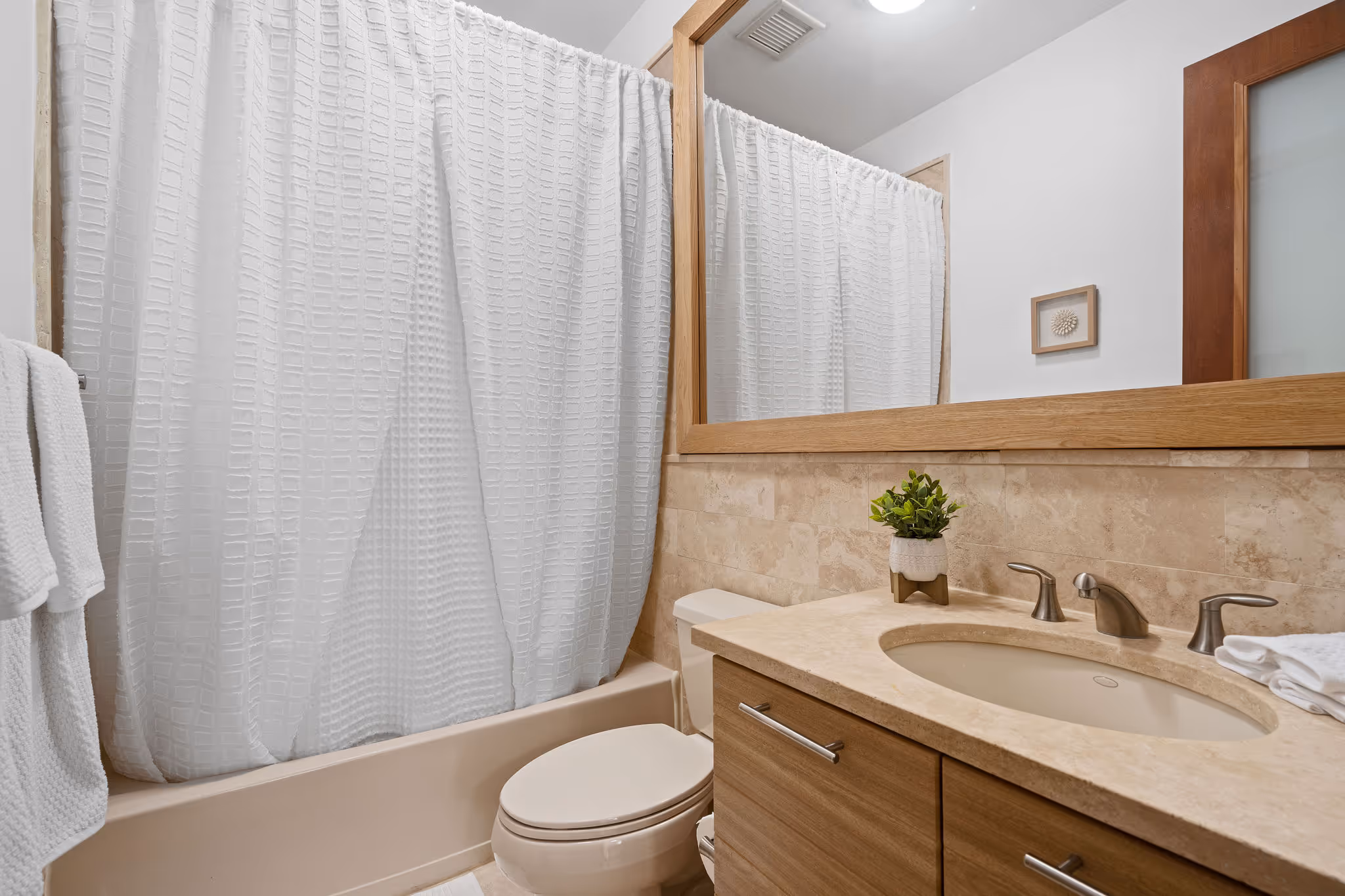 En-suite bathroom with tub, vanity, and neutral tones in guest suite at Plantation Village Dorado Beach