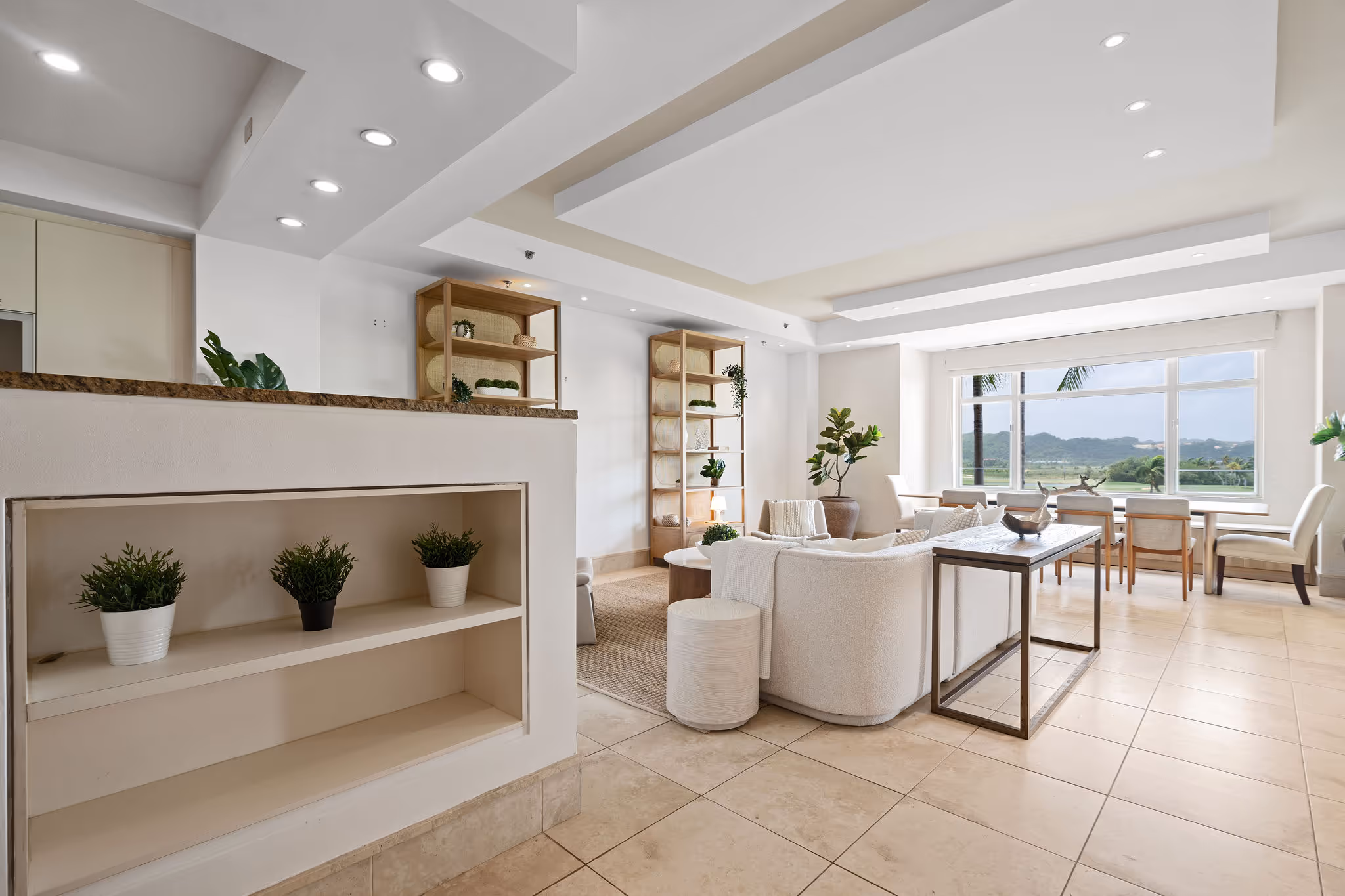Bright and spacious living and dining area with panoramic golf course and mountain views in Dorado Beach Resort condo