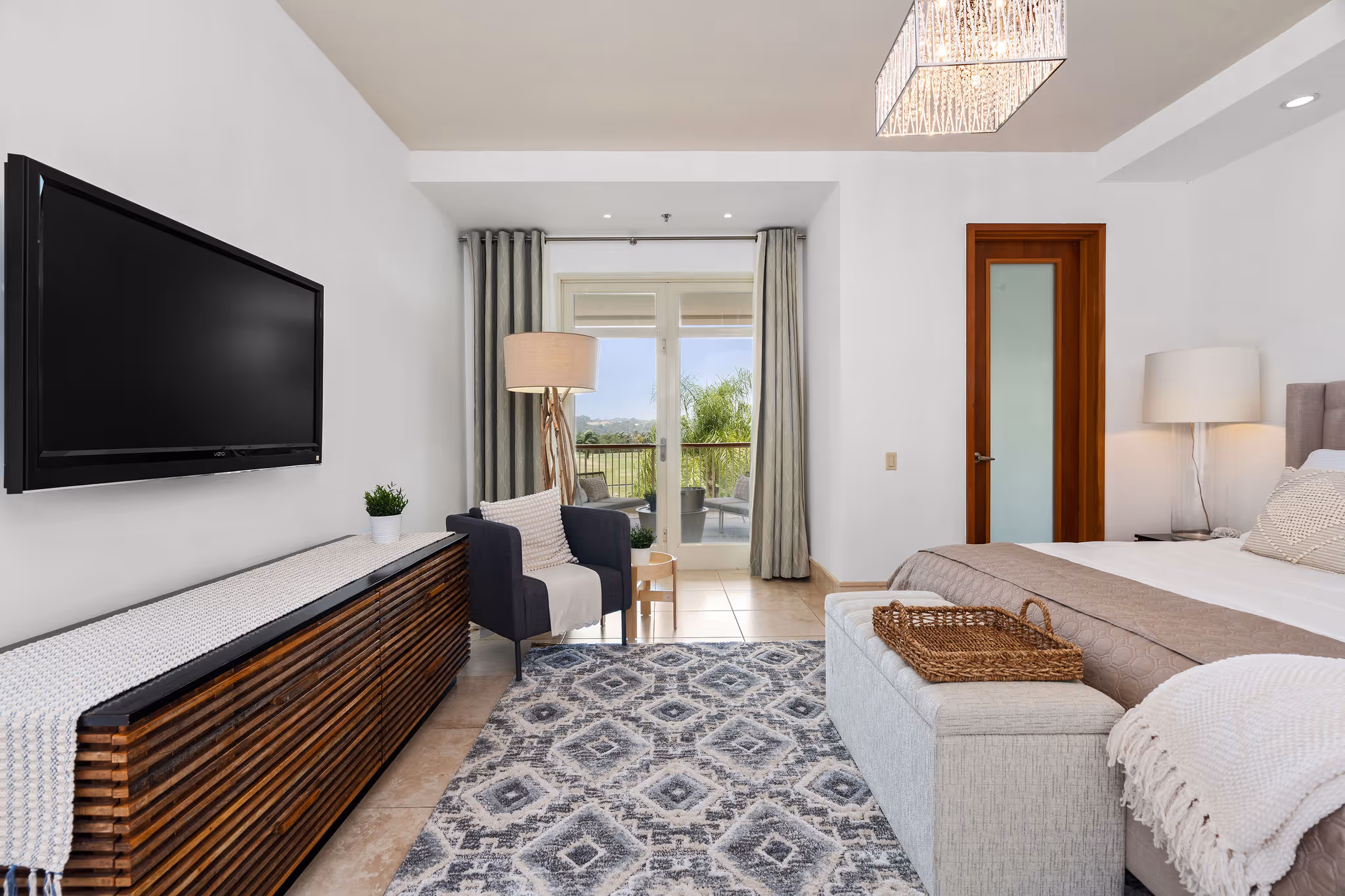 Spacious primary suite with natural light and direct access to private balcony at Dorado Beach luxury residence