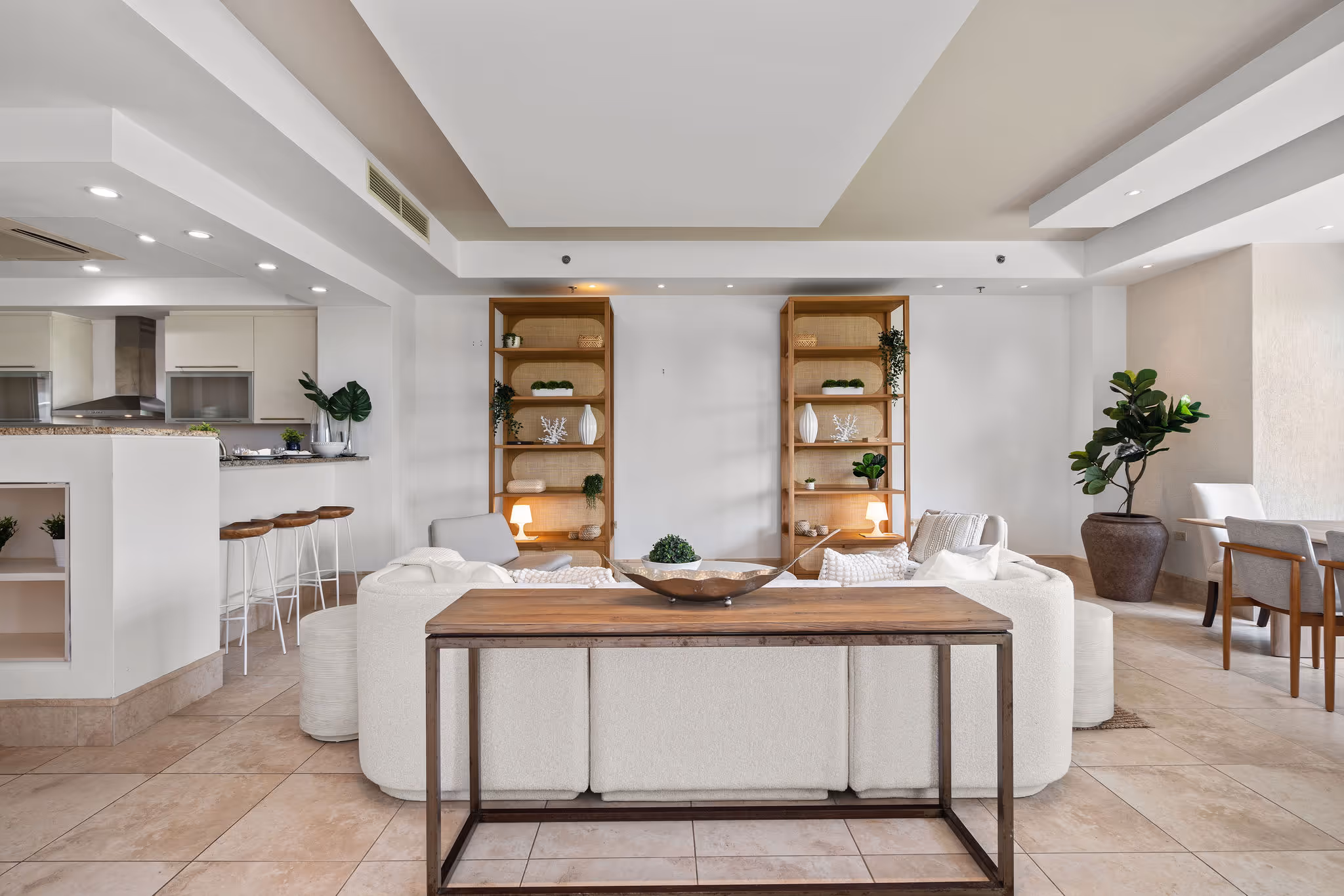 Stylishly furnished living room with custom shelving and open layout facing TPC Sugarcane Golf Course in Dorado Beach