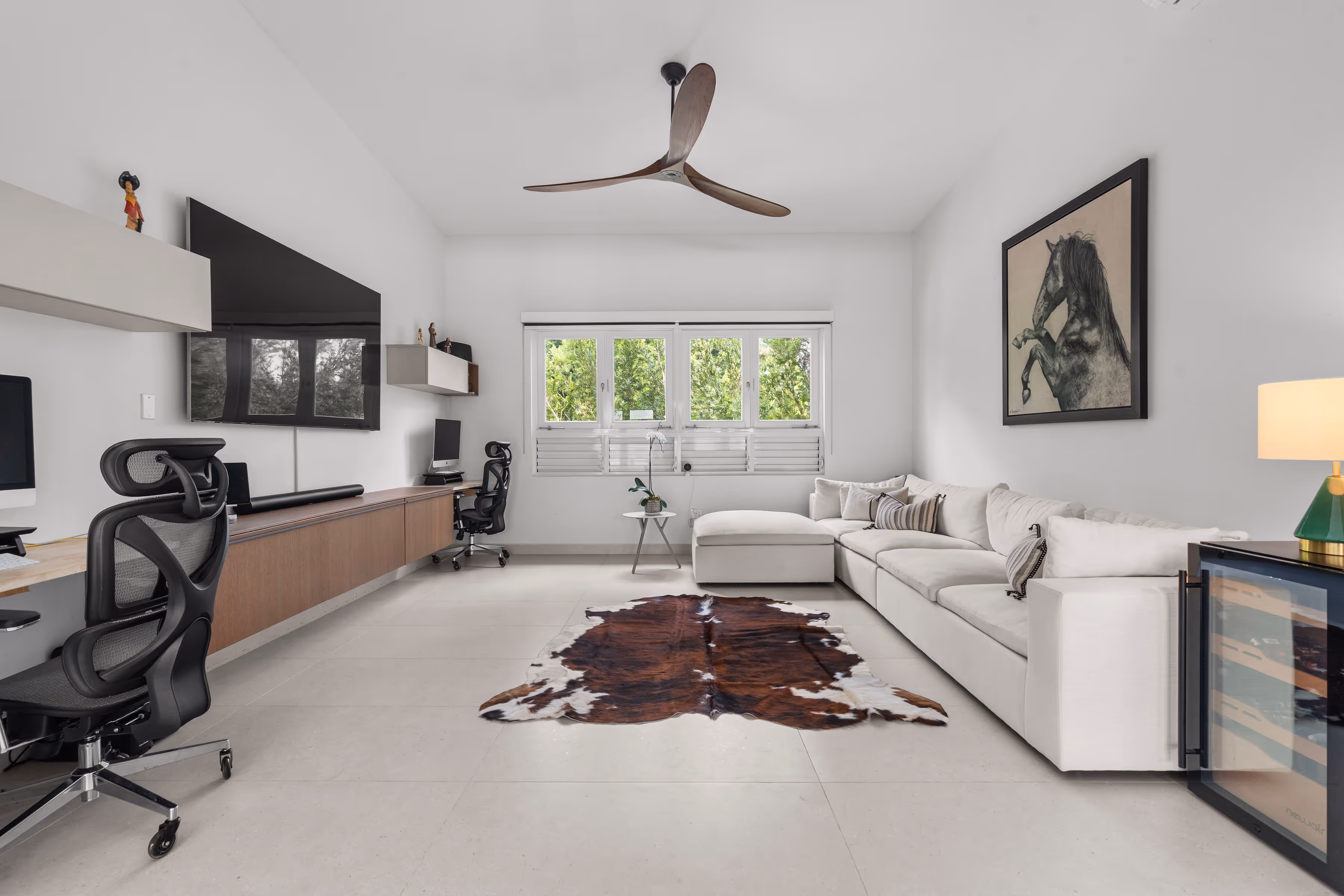 Private backyard retreat with swimming pool and deck surrounded by lush greenery