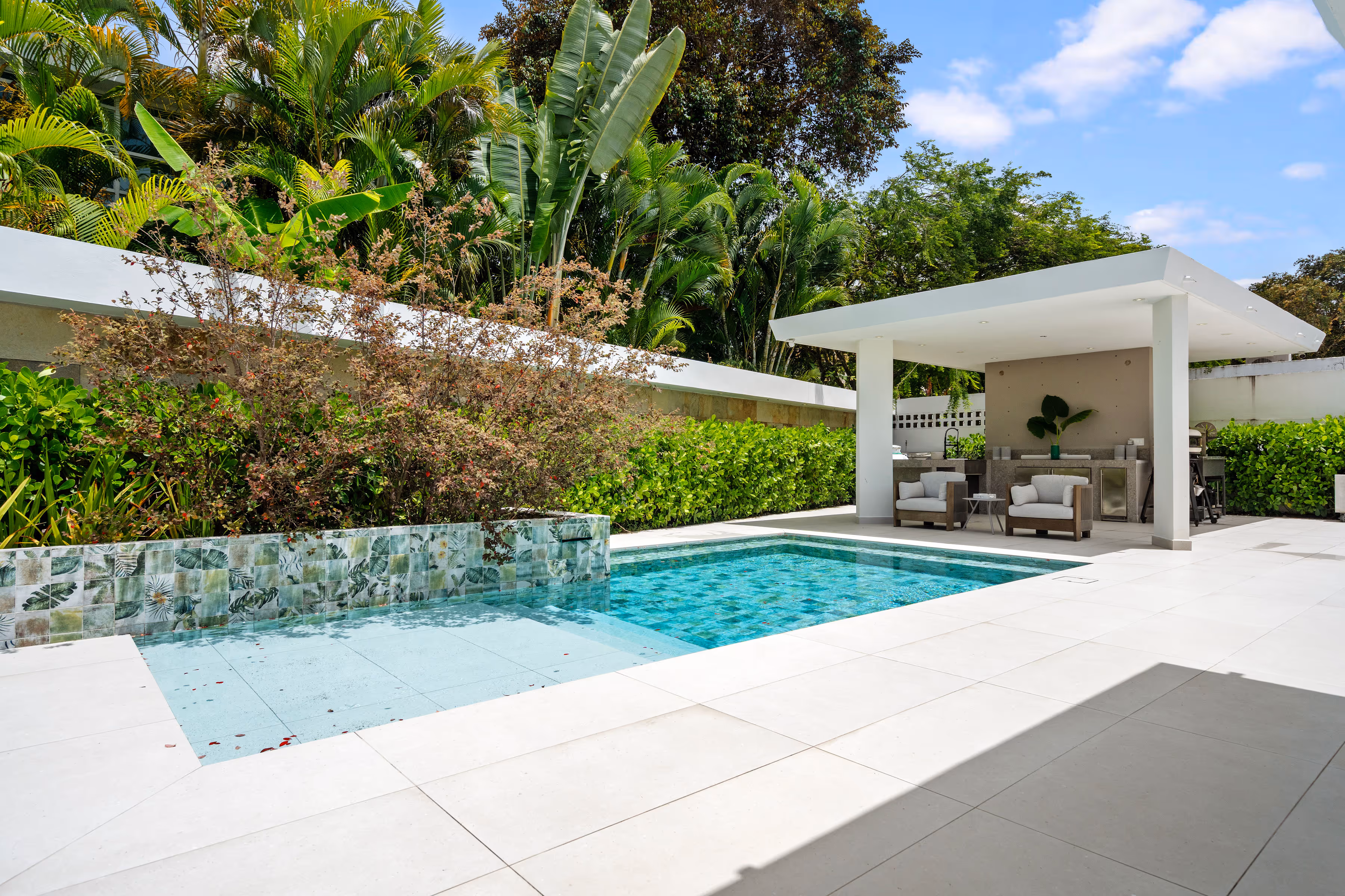 Front facade of mid-century modern home with enclosed and open garages