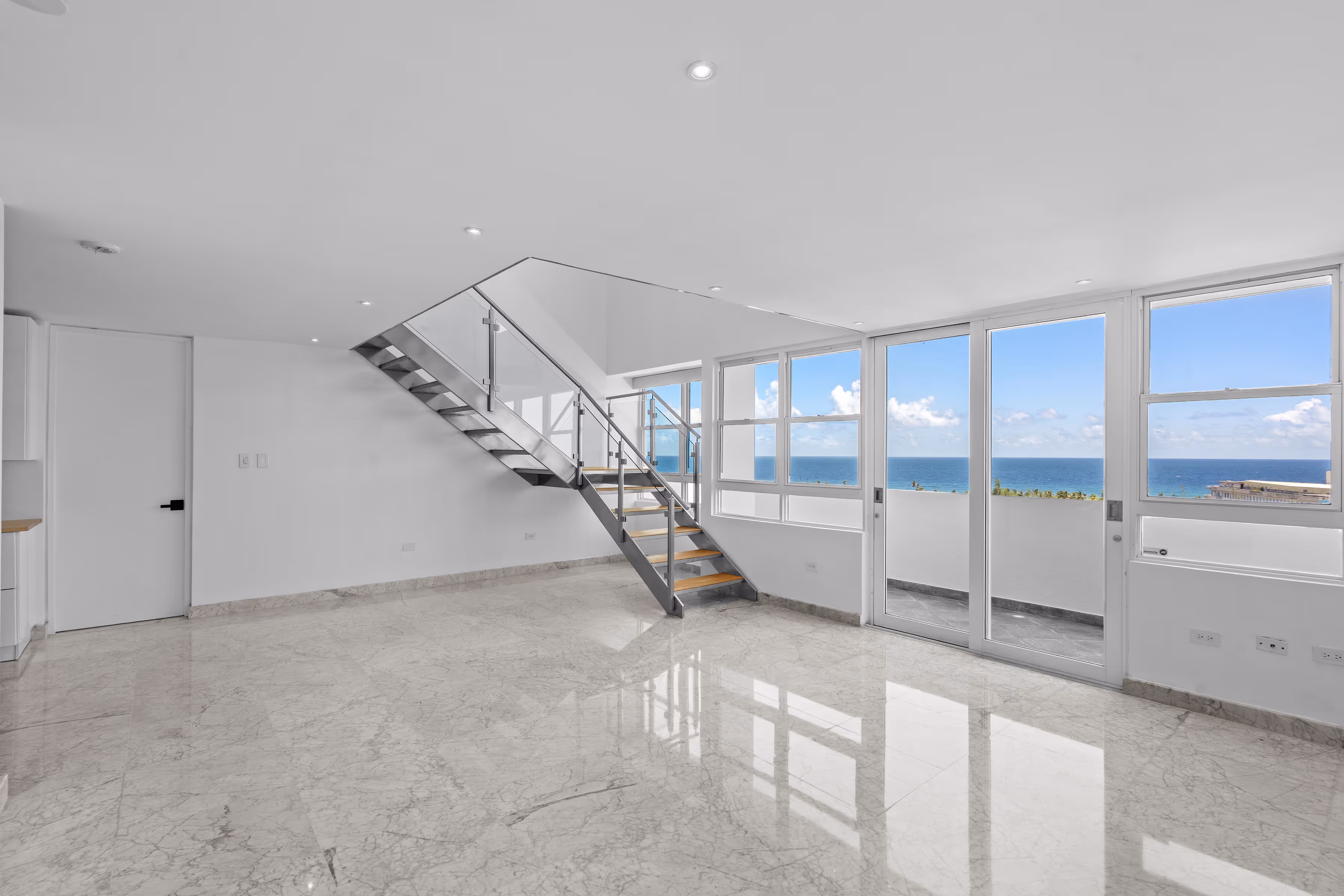 Remodeled San Juan penthouse living room with expansive interiors and dining area