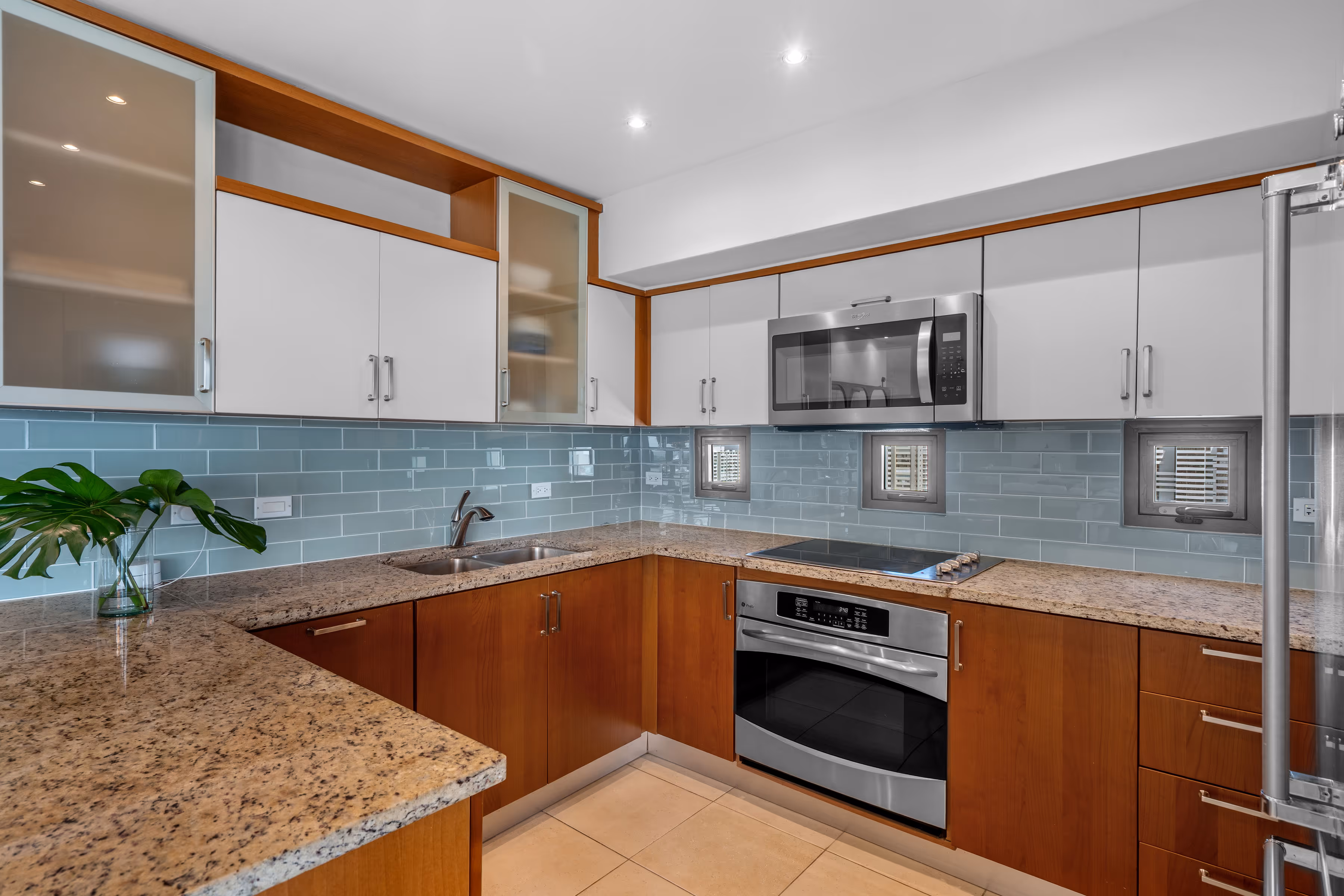 Modern kitchen appliances with granite island in Gallery Plaza condo Puerto Rico