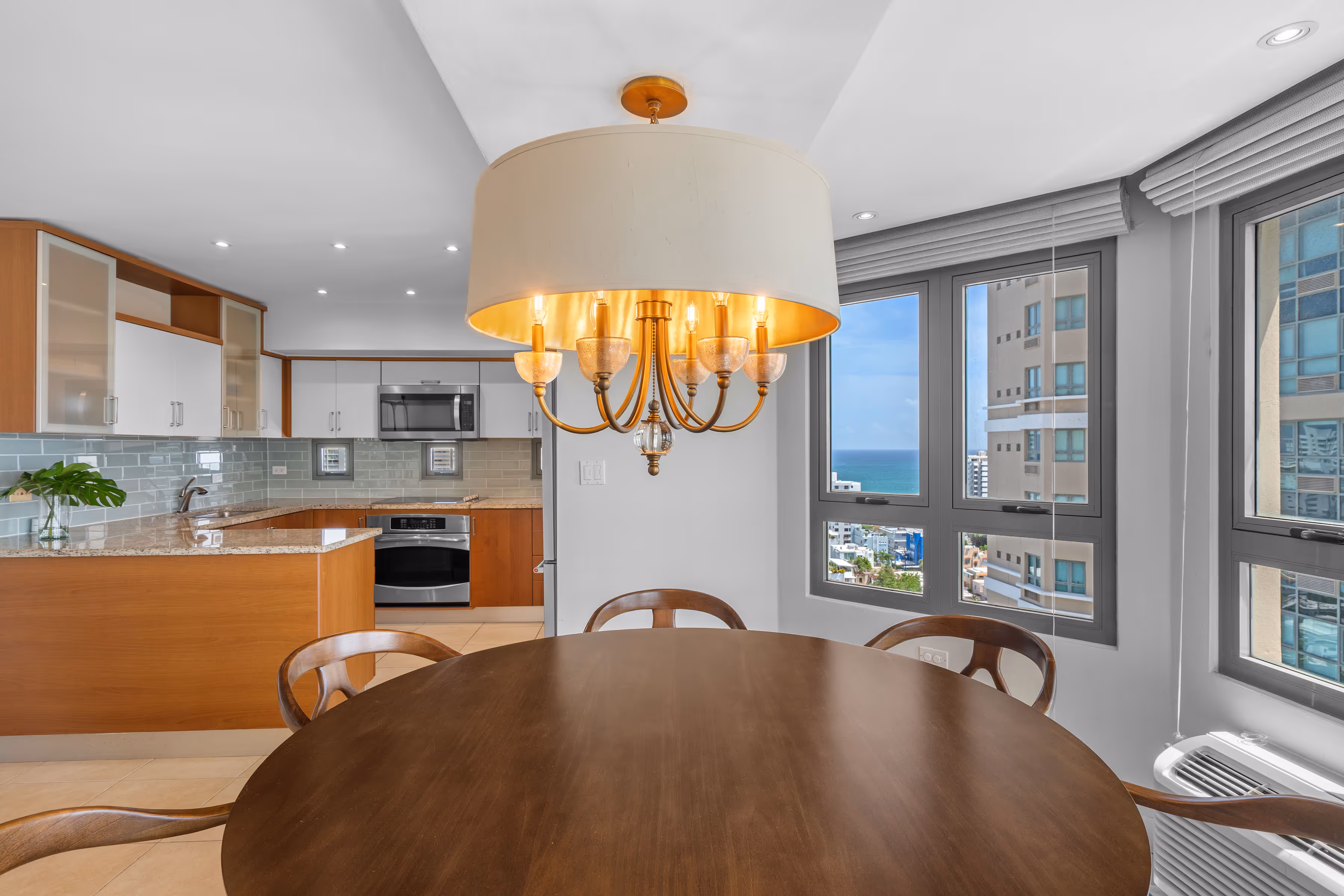 Dining area with panoramic San Juan skyline and Atlantic backdrop in luxury condo