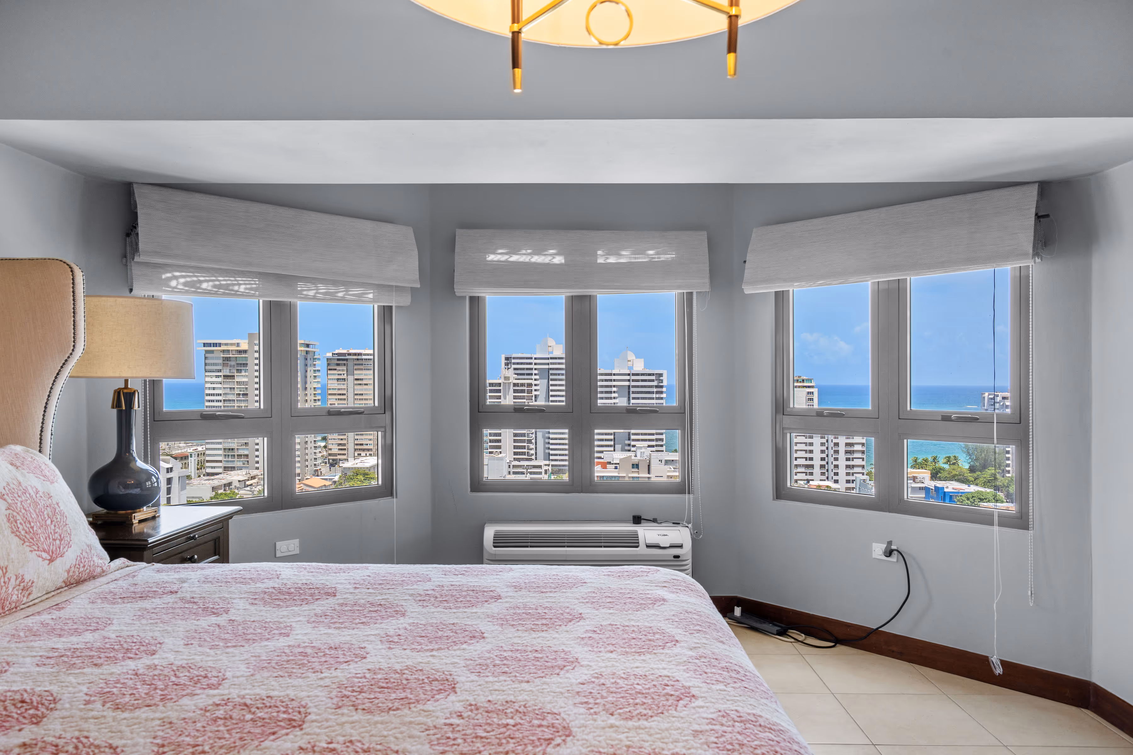 Primary bedroom with ocean view and walk-in closet in Condado condo