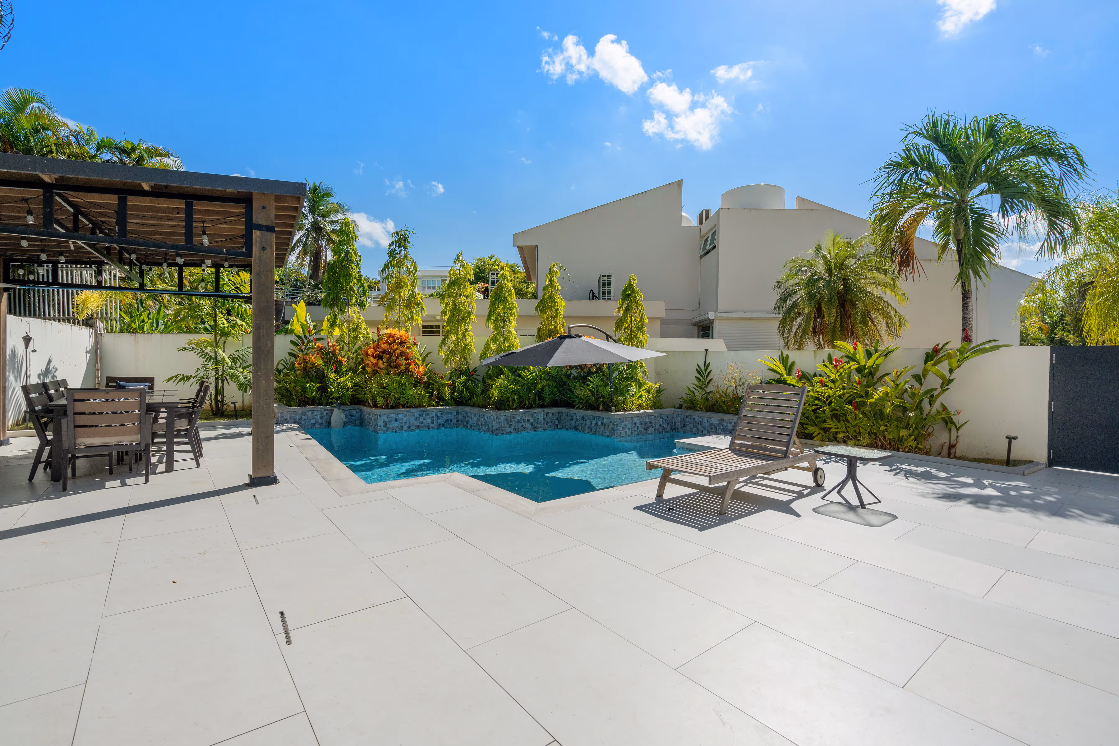 Heated pool with water fountains and teak outdoor shower