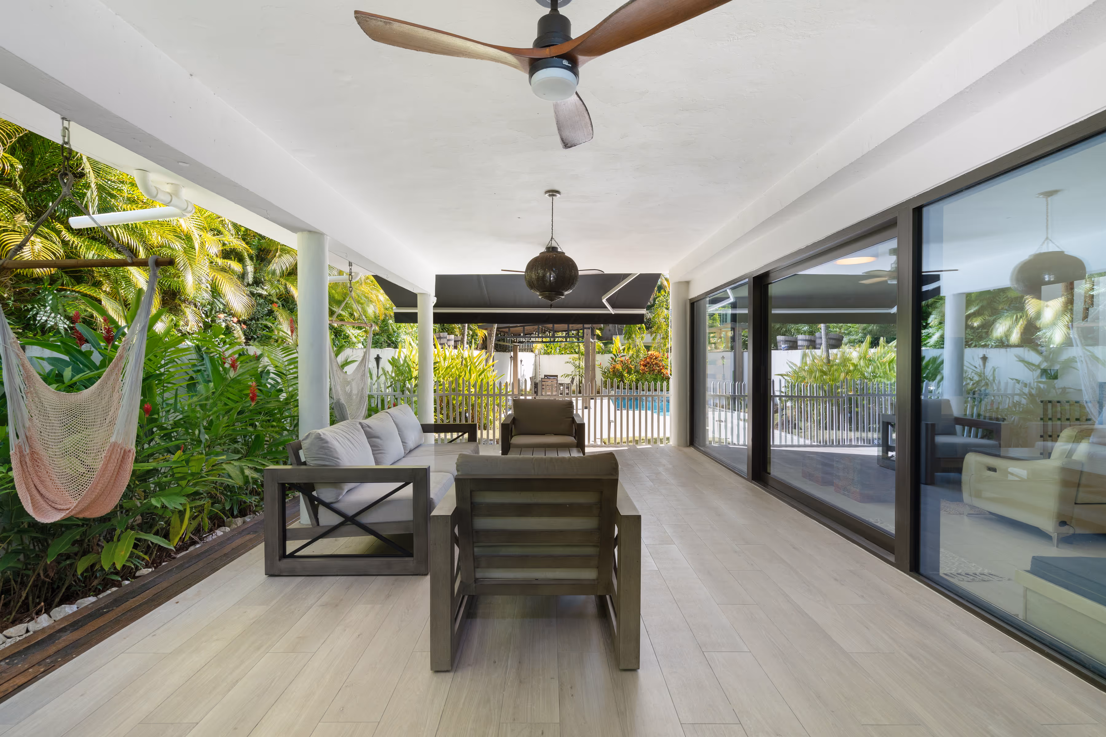 Covered lanai with outdoor dining table and gas grill