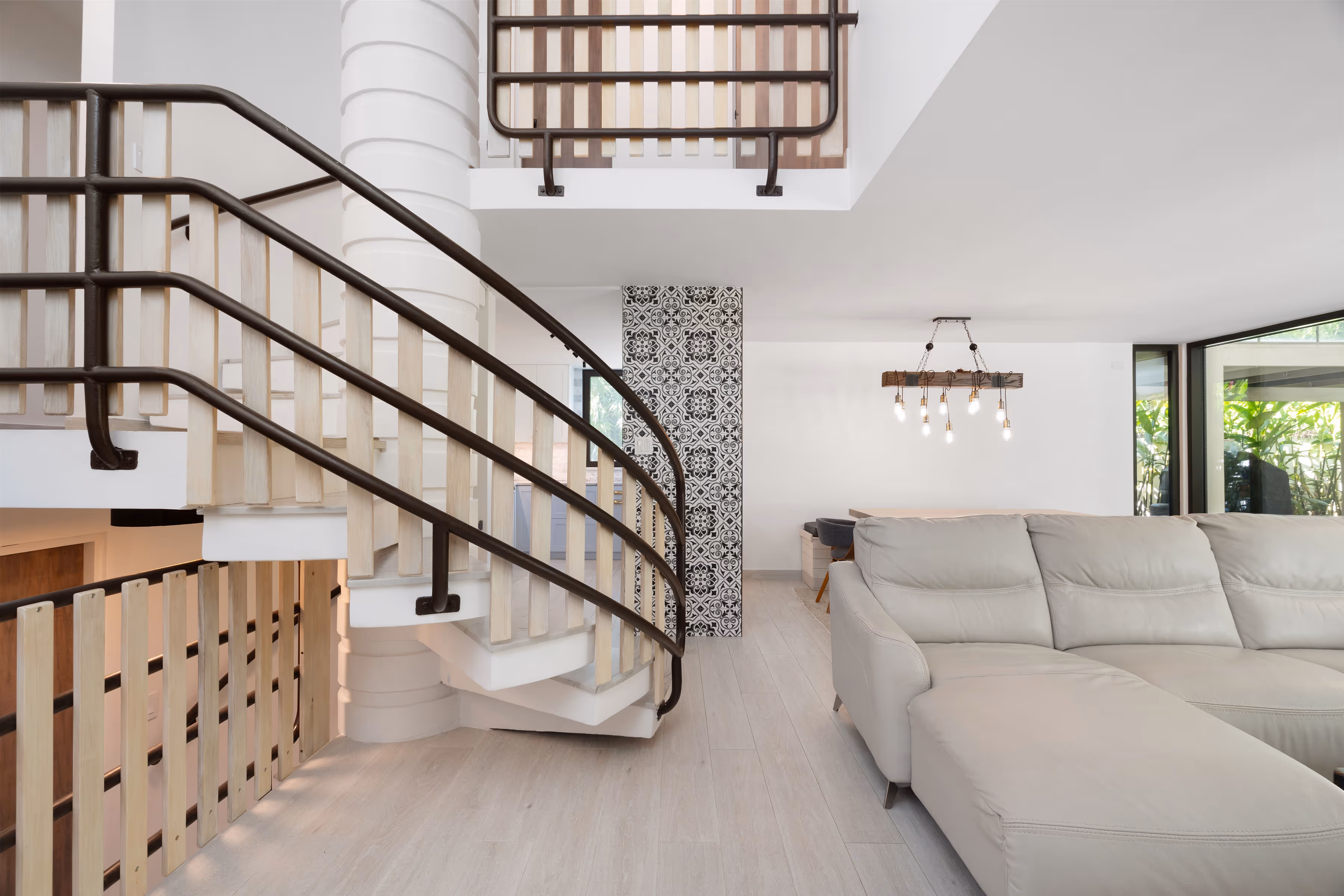 Outdoor pool area with porcelain deck and tropical greenery