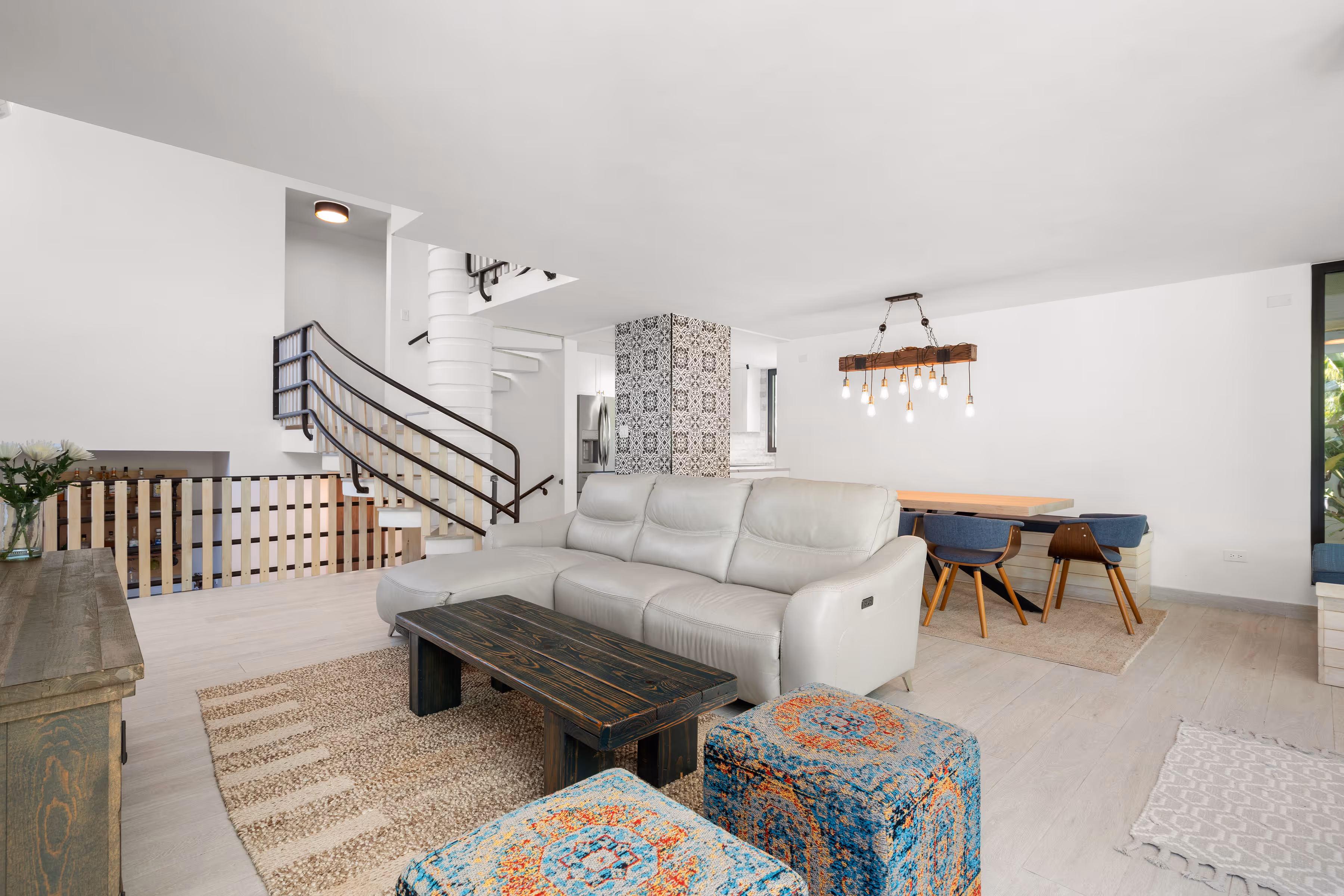 Open concept living room with lift-and-slide glass wall to patio