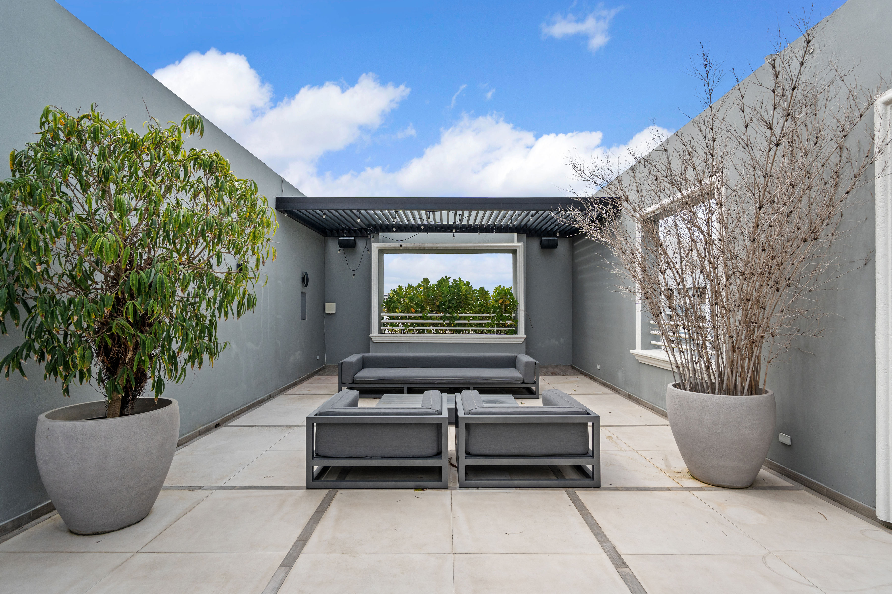 Spacious primary bathroom with soaking tub and dual shower in penthouse