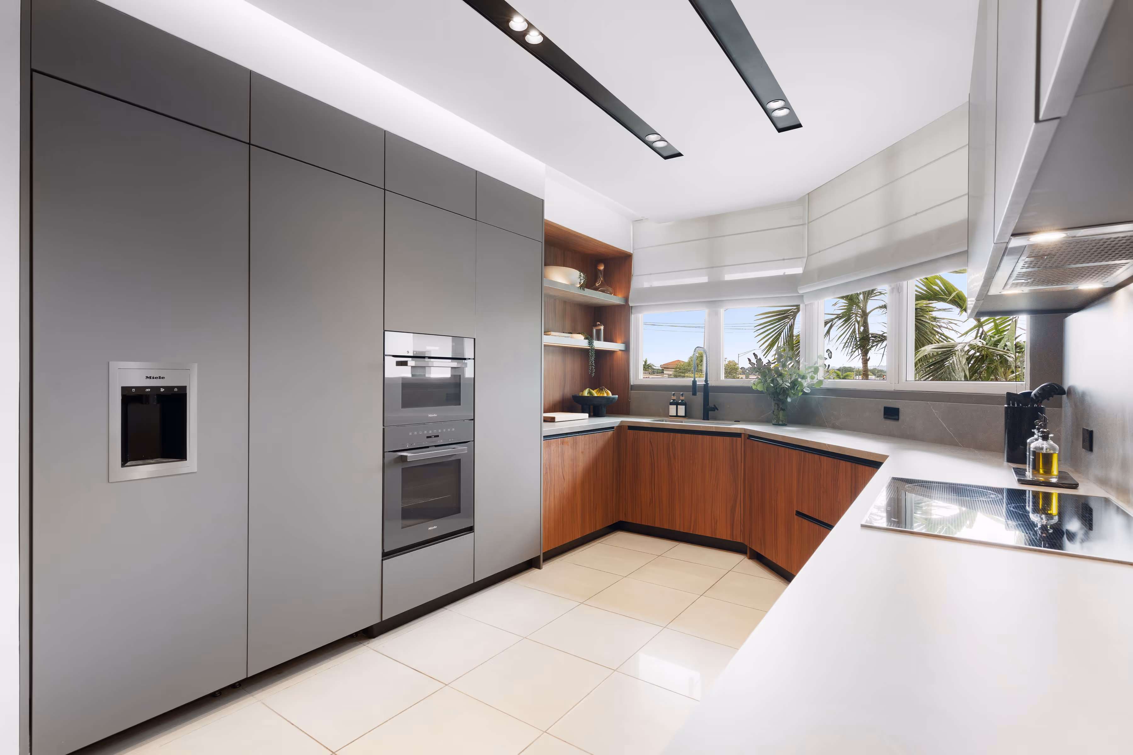 Fully equipped modern kitchen featuring stainless steel appliances and minimalist hardware.