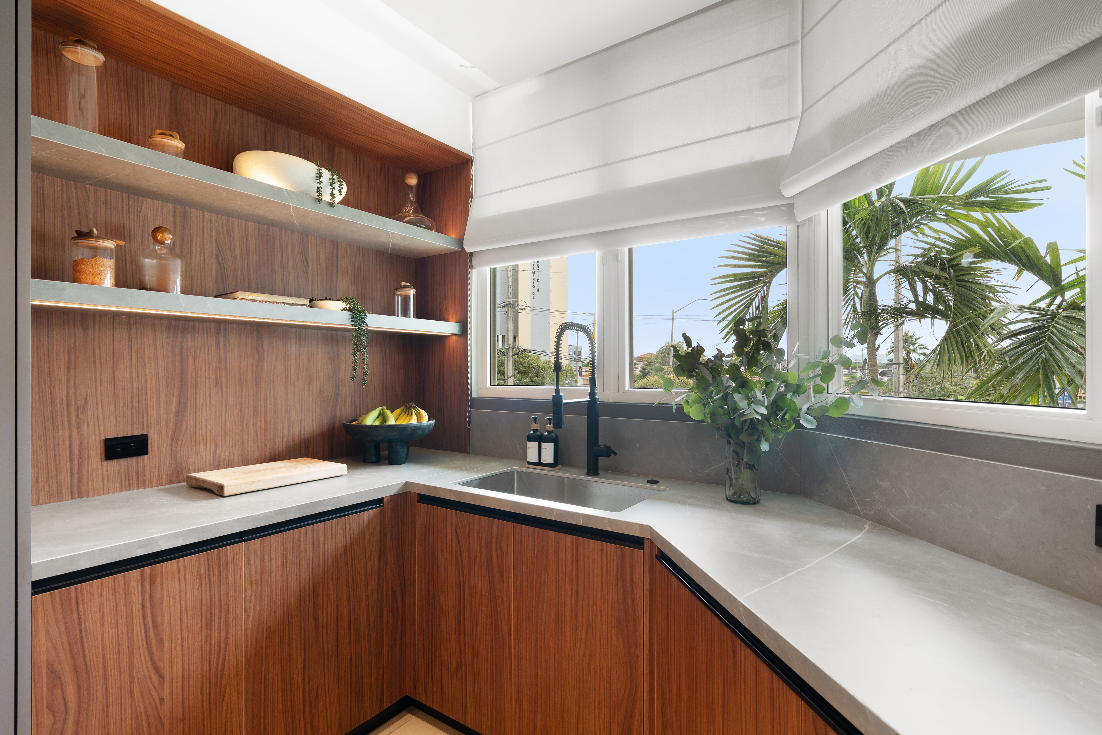 Primary suite with a warm masculine aesthetic and large windows for natural light.