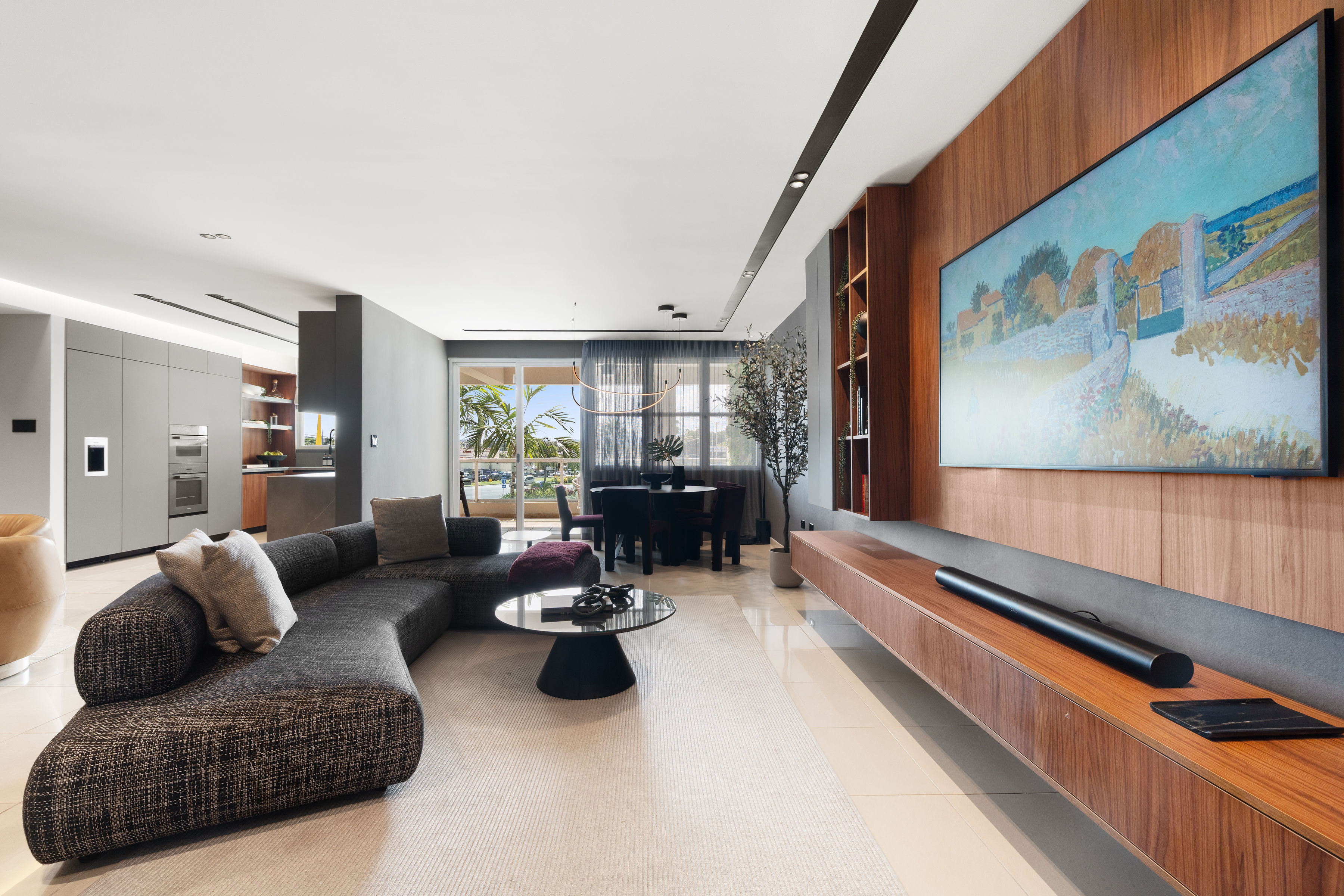 Open-concept dining area at Cognac Residence featuring natural wood textures and grey tones.