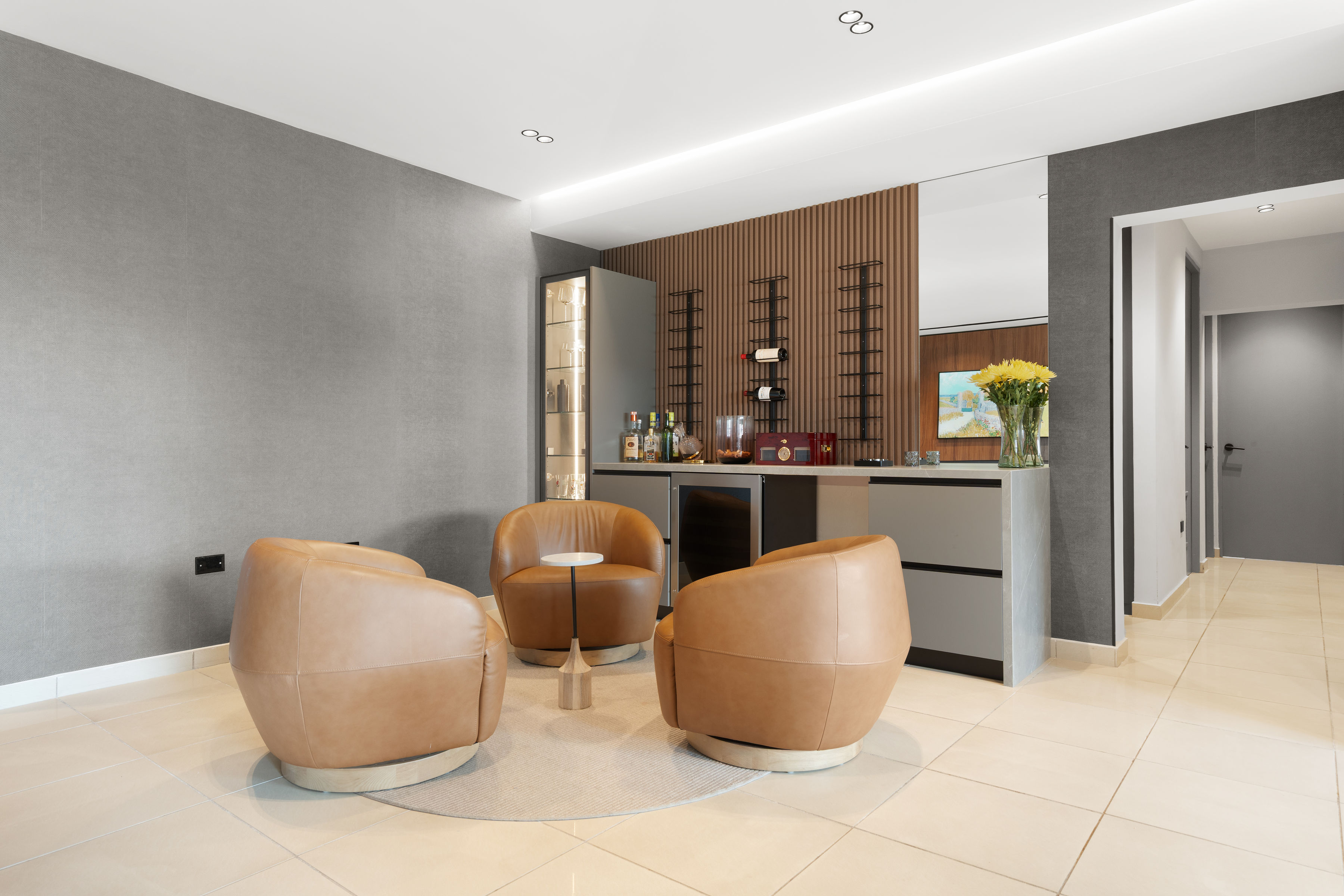 Gourmet kitchen with matte black cabinetry, modern appliances, and integrated lighting.