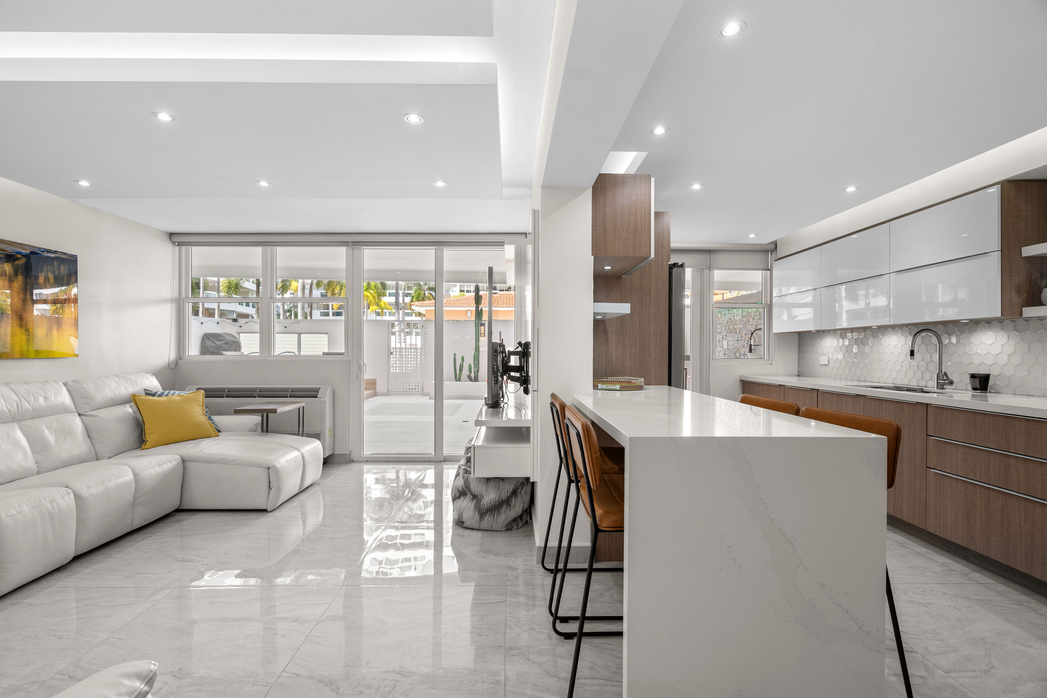 Astralis Isla Verde modern kitchen with island seating and open concept living space