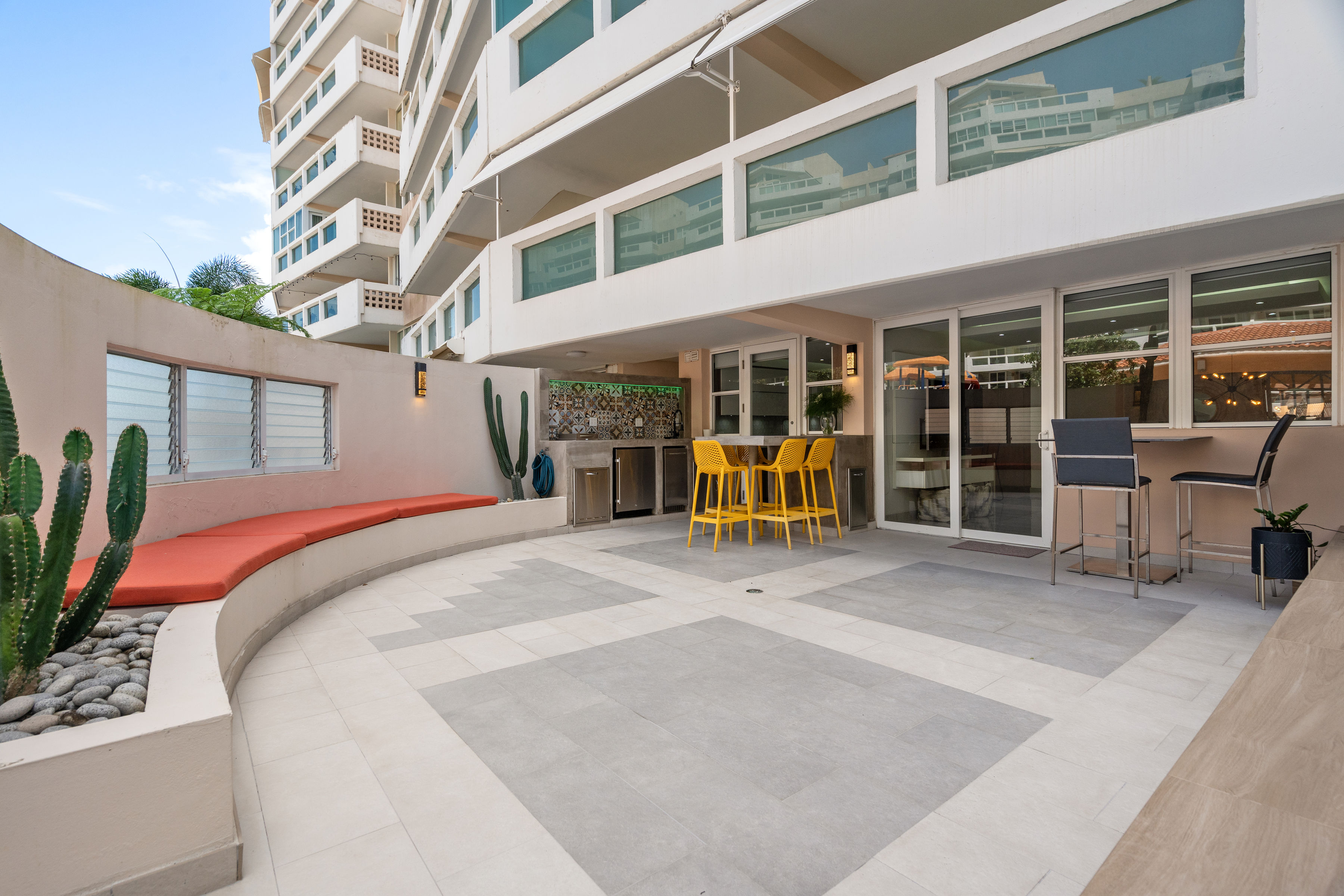 Astralis Residences garden terrace with outdoor kitchen and seating area