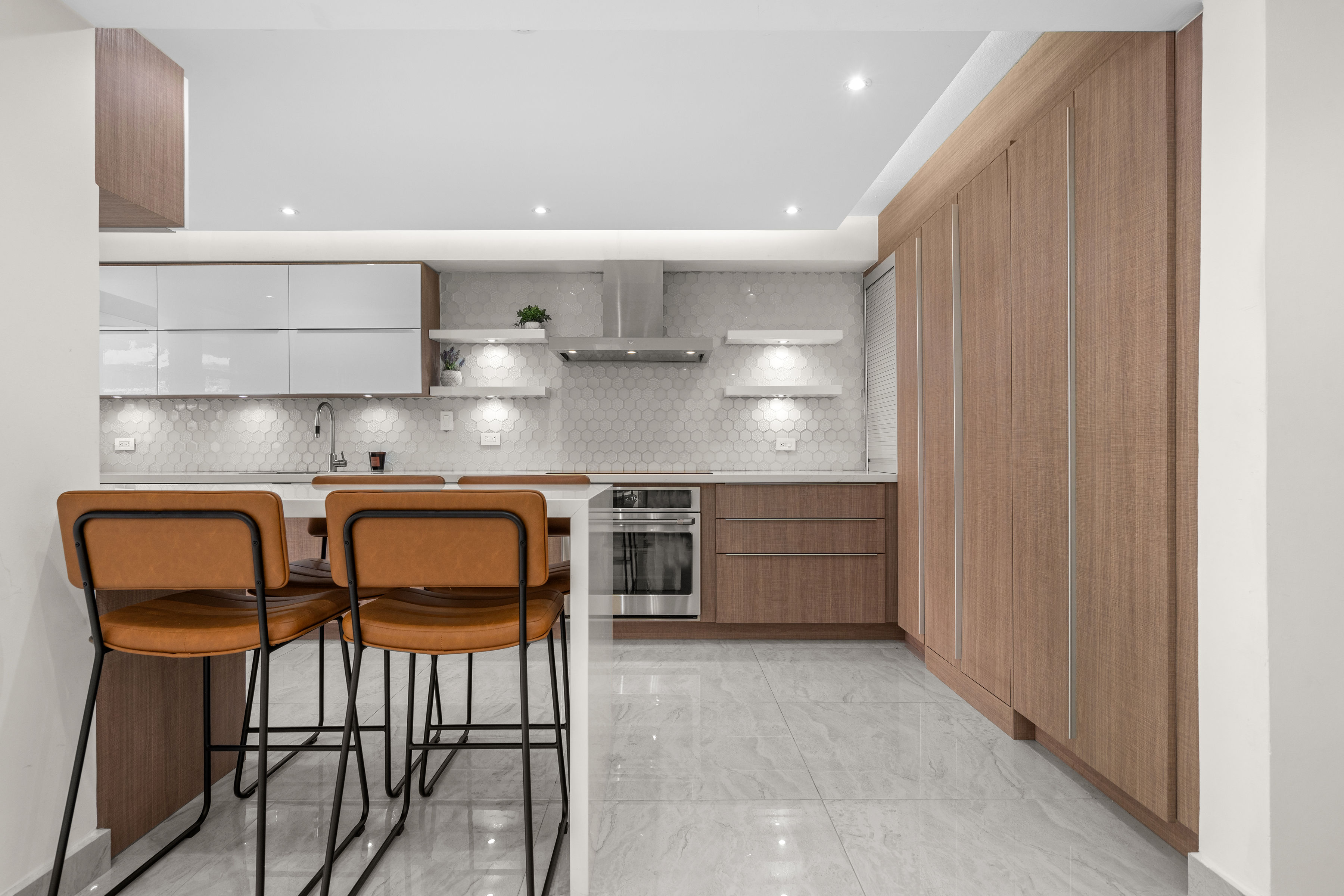 Astralis Residences kitchen with custom cabinetry, quartz countertops and bar seating