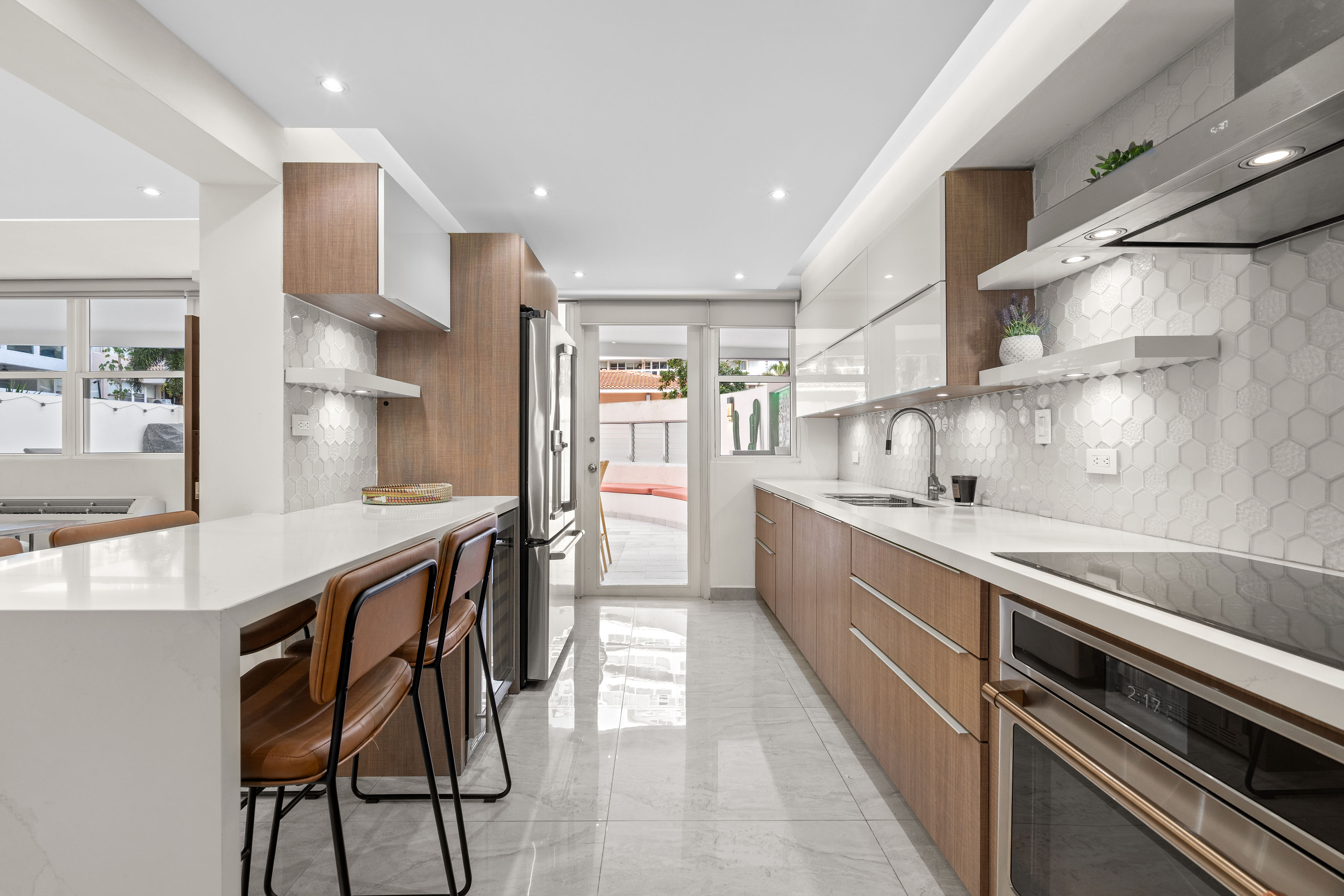 Astralis Residences open concept kitchen and living area with natural light and terrace access